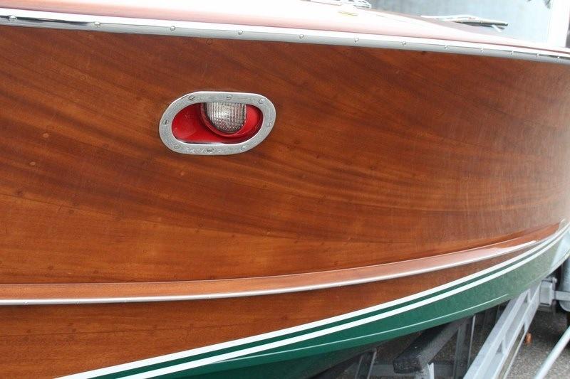 1956 Riva Tritone boat with wooden finish and red light.
