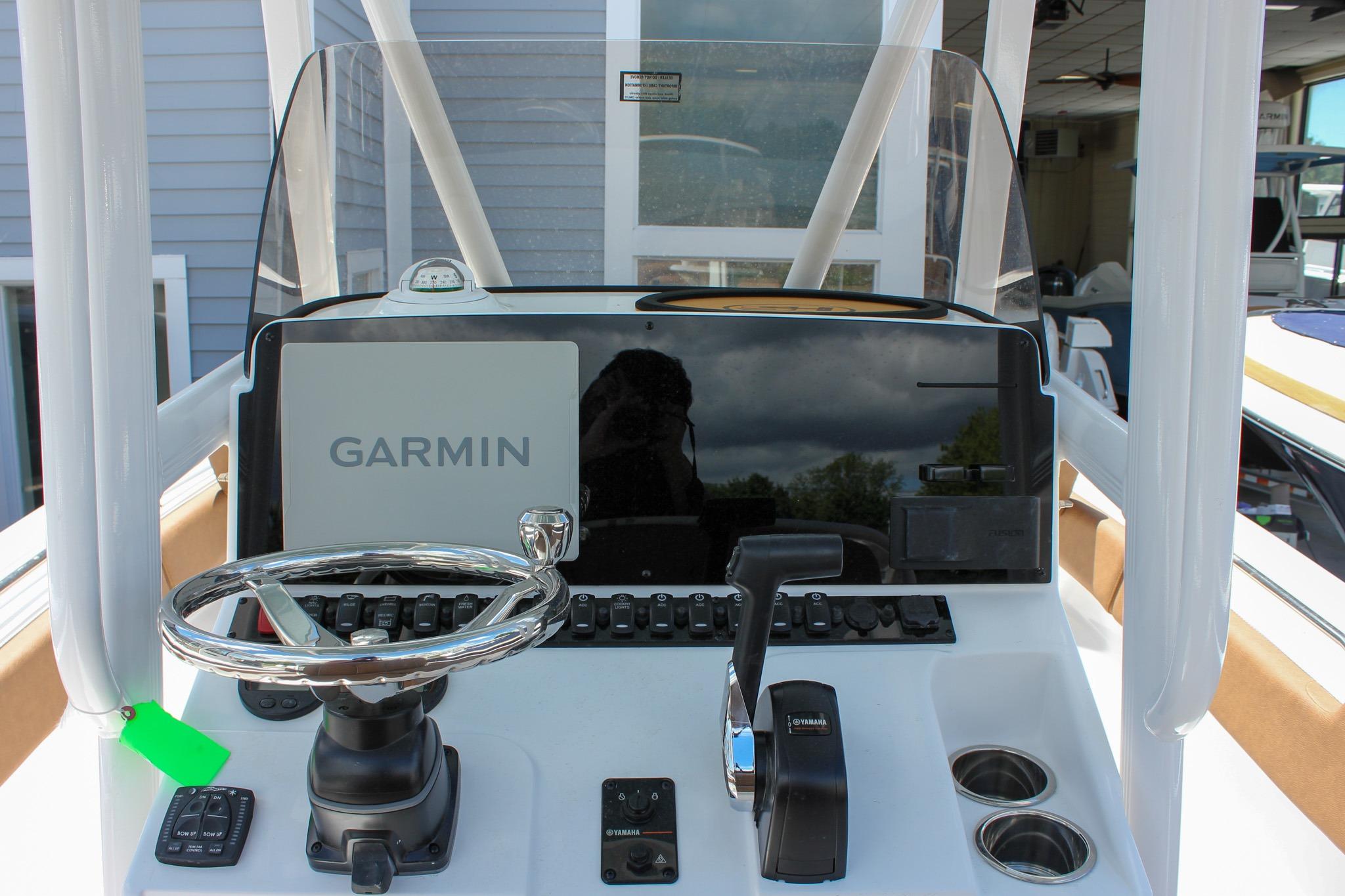 2027 Sea Hunt Ultra 234 boat dashboard with Garmin navigation system and steering wheel.