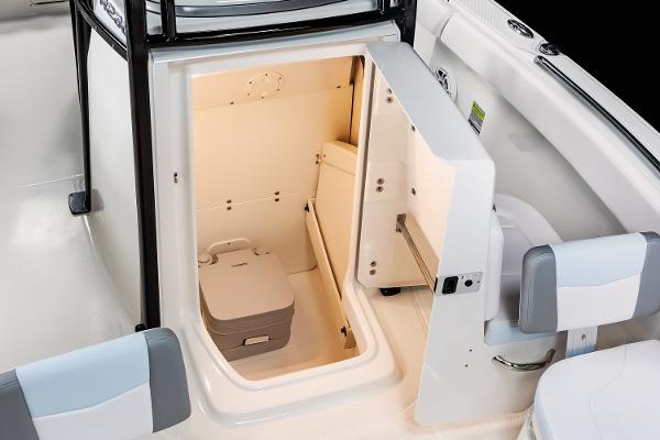 Manufacturer Provided Image: 2025 Robalo R232 Explorer boat interior with compact cabin and portable toilet.