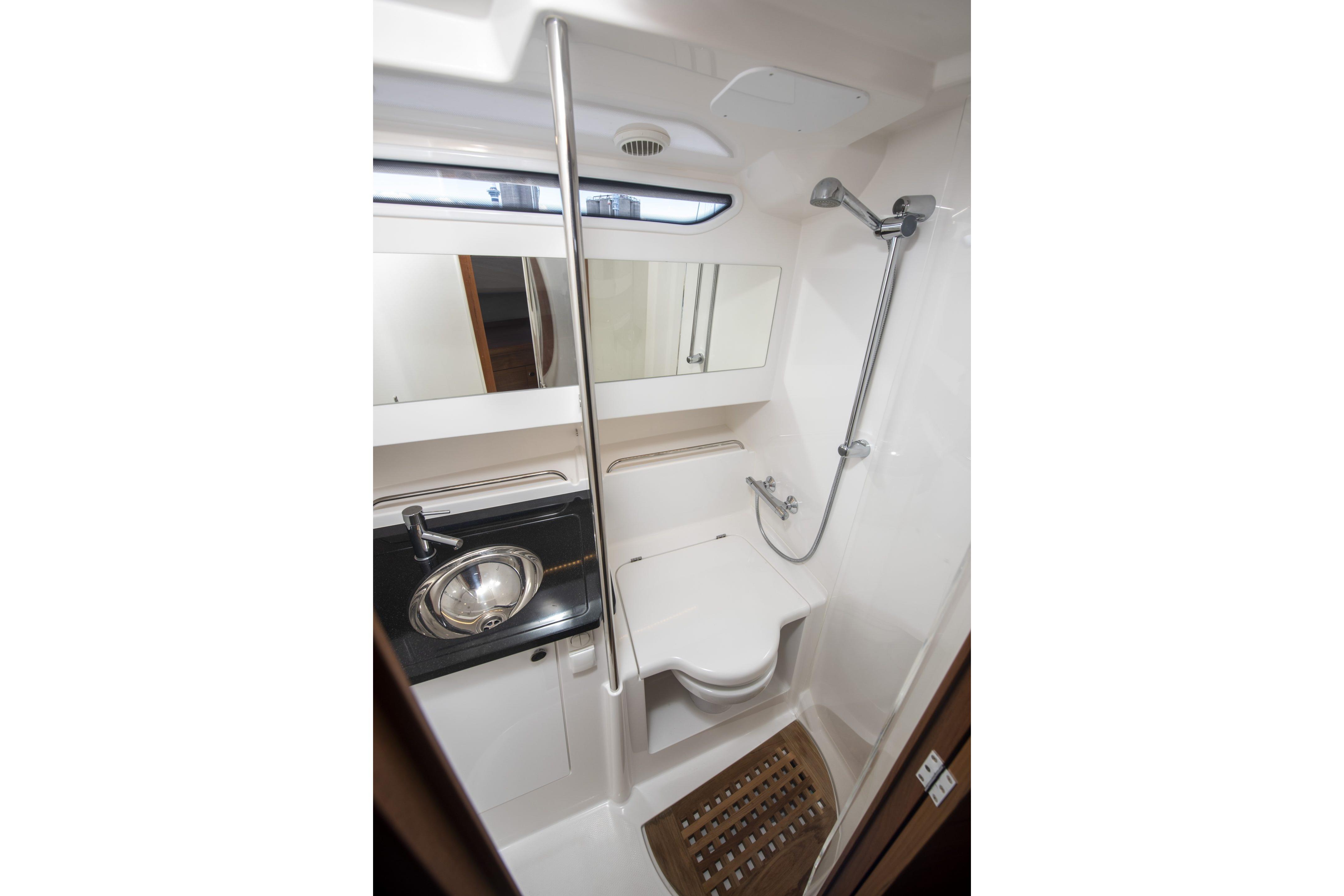 Modern bathroom in 2025 Nimbus Tender 11 yacht with shower and sink.