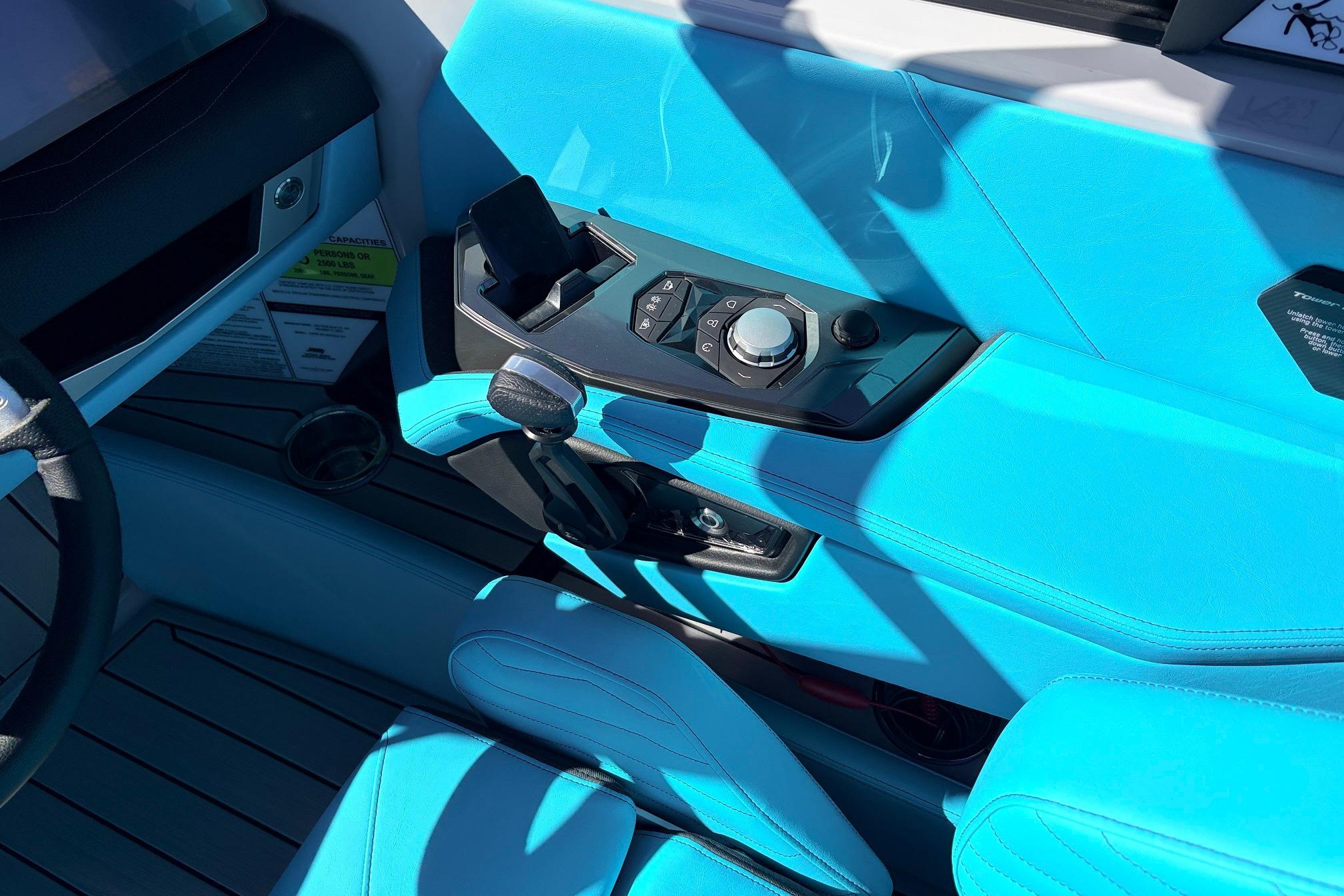 Interior of 2026 Nautique Super Air Nautique G23 with blue upholstery and control panel.