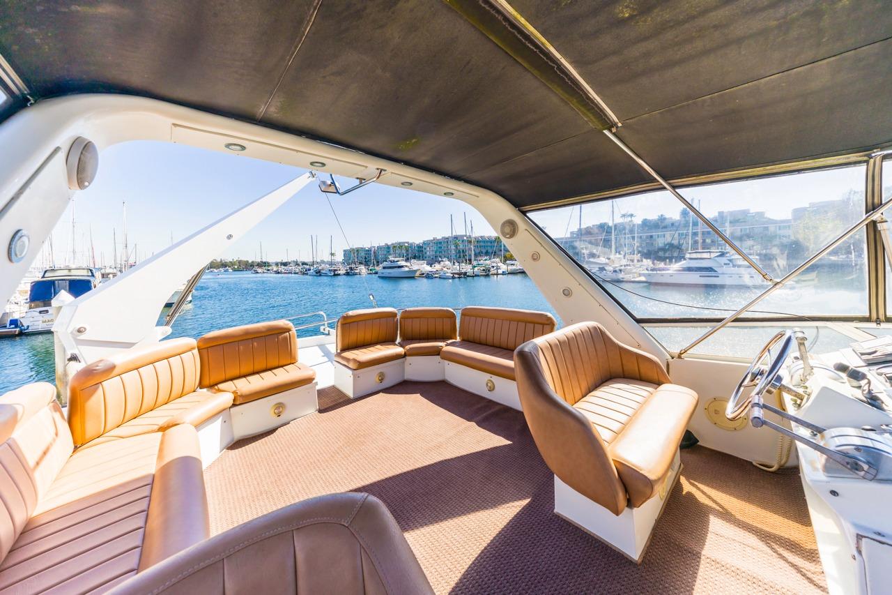 Spacious interior of 1996 Navigator 5300 Classic yacht with leather seating and marina view.