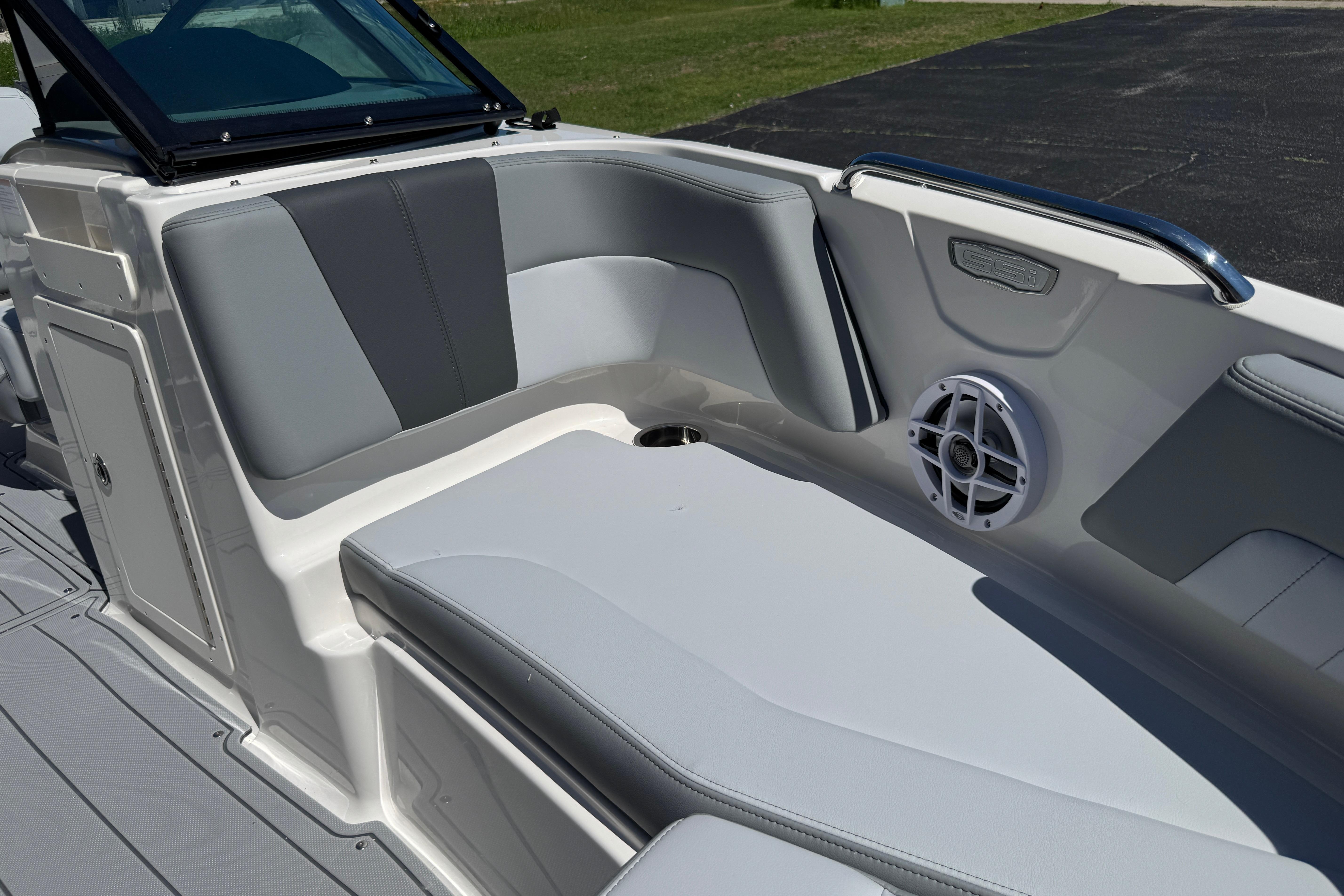 2026 Chaparral 21 SSi boat interior with gray seating and speaker detail.