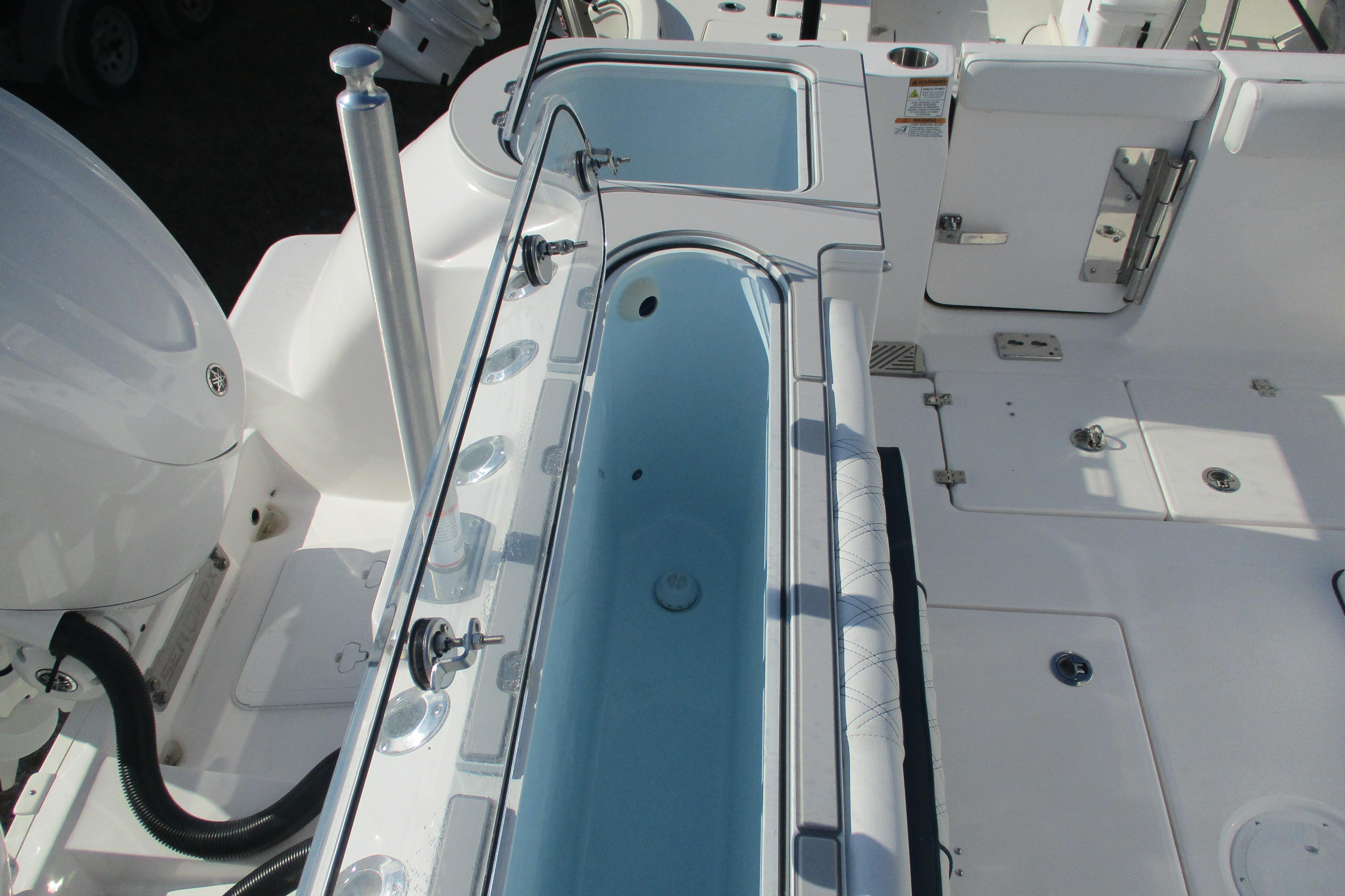 2026 Sea Fox 328 Commander boat deck with livewell and storage compartments.