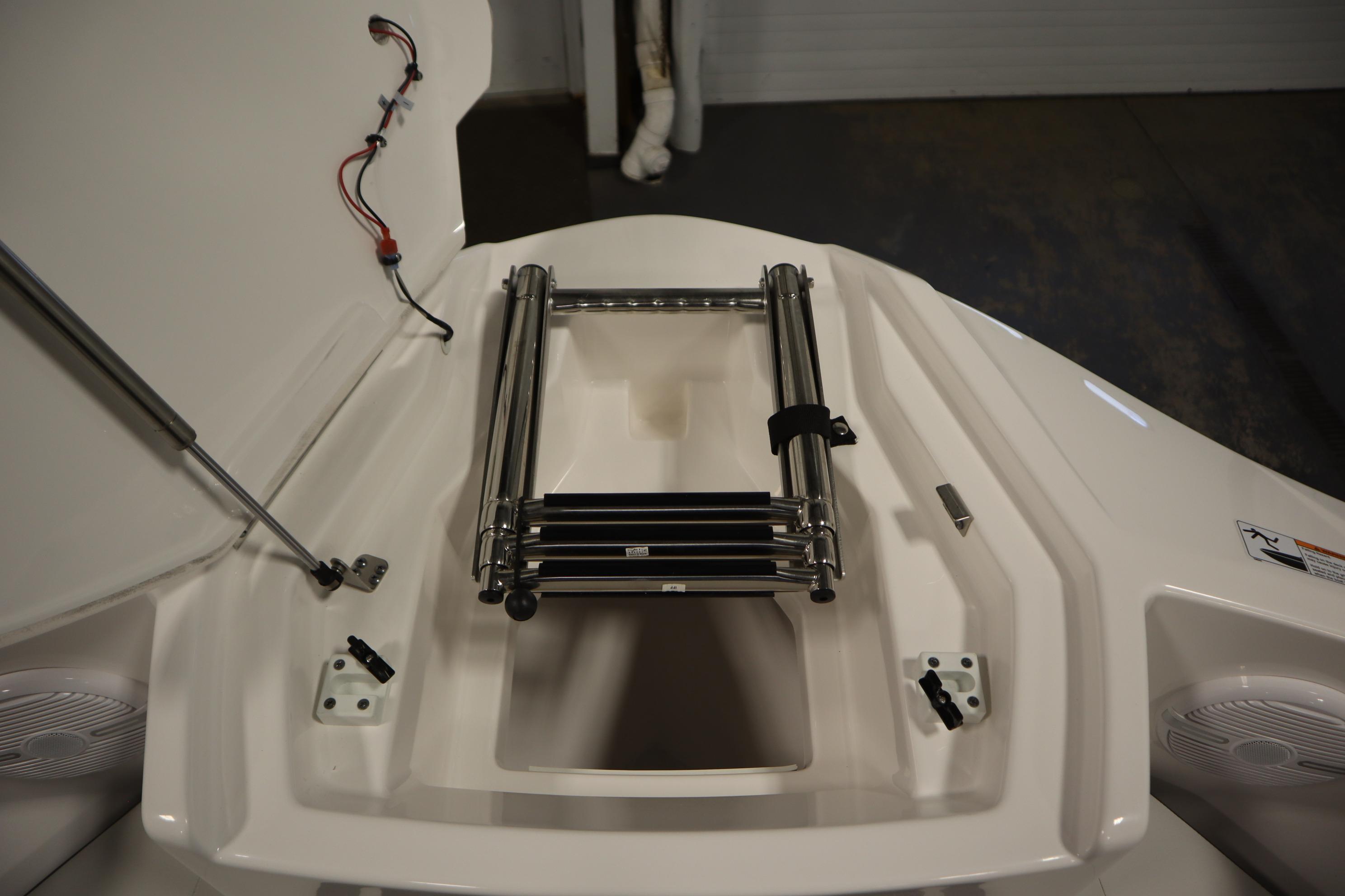 2026 Yamaha Boats AR220 bow with ladder and storage compartment.