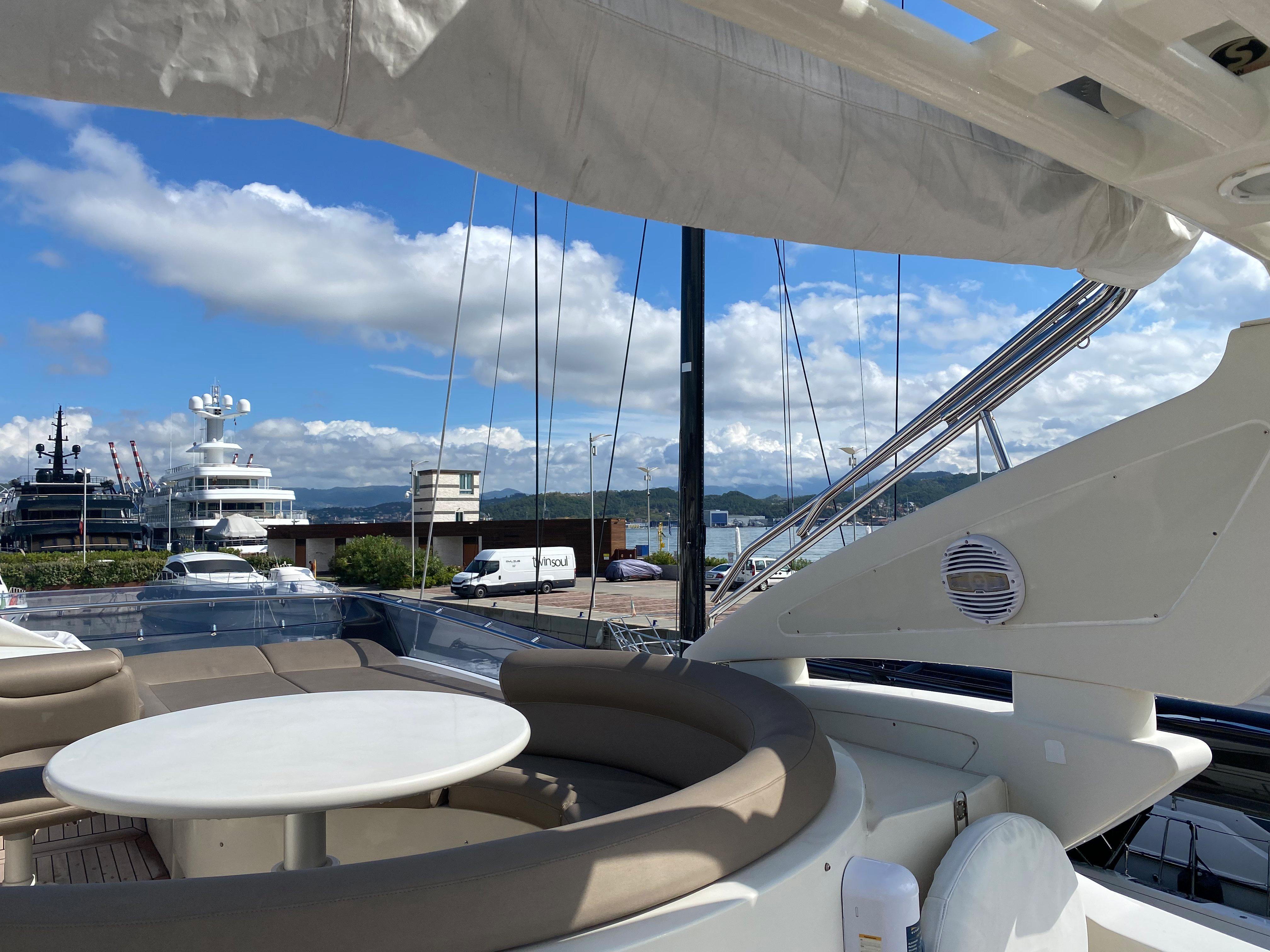 Luxury yacht deck with seating area, Dominator 680, 2008 model, docked at marina.