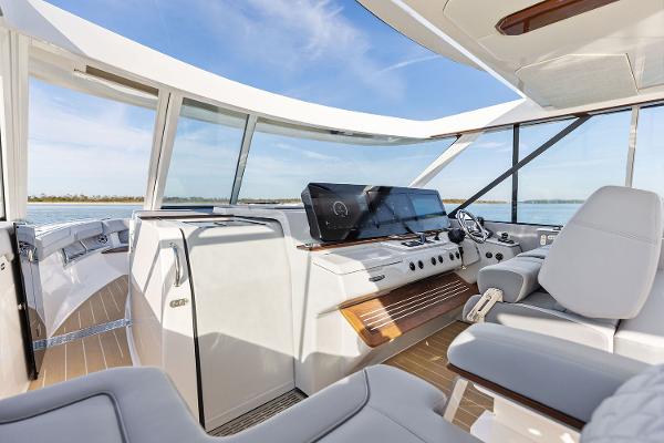 Manufacturer Provided Image: Luxurious interior of 2026 Regal LX43 yacht with modern helm and panoramic windows.