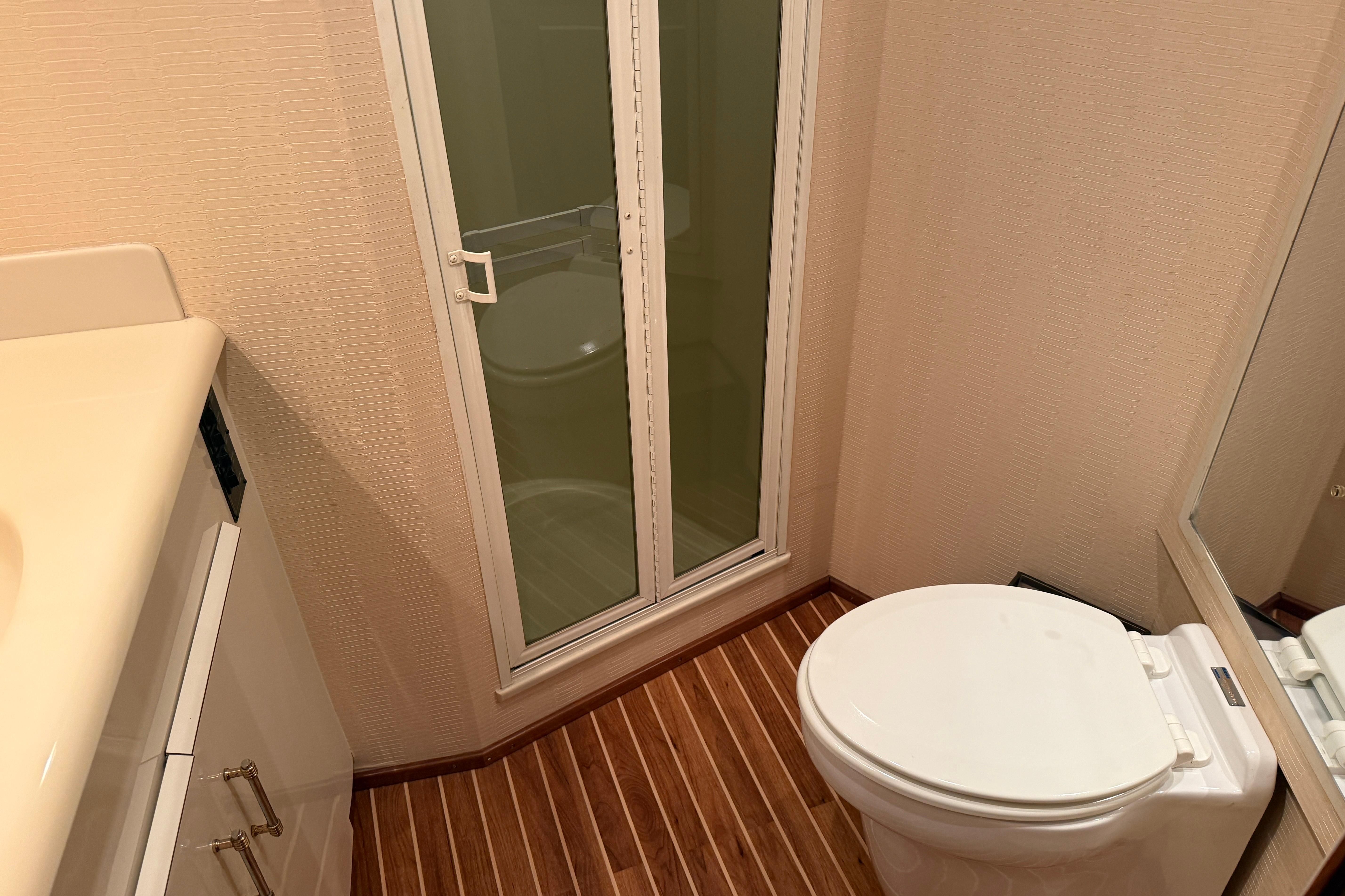 Bathroom interior of 2000 Viking 55 Convertible yacht with shower and toilet.