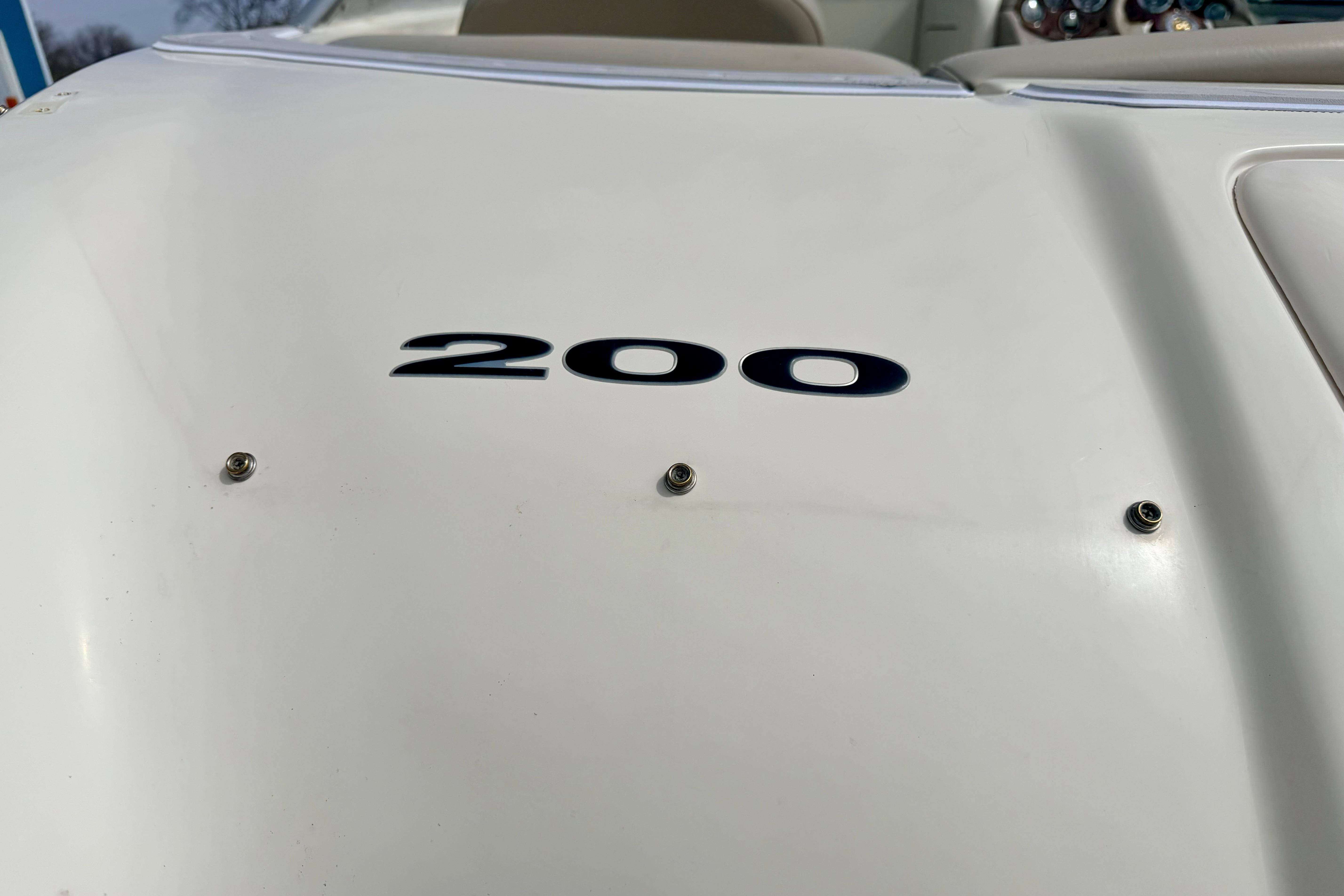 2003 Sea Ray 200 Sundeck boat with visible model number on white surface.