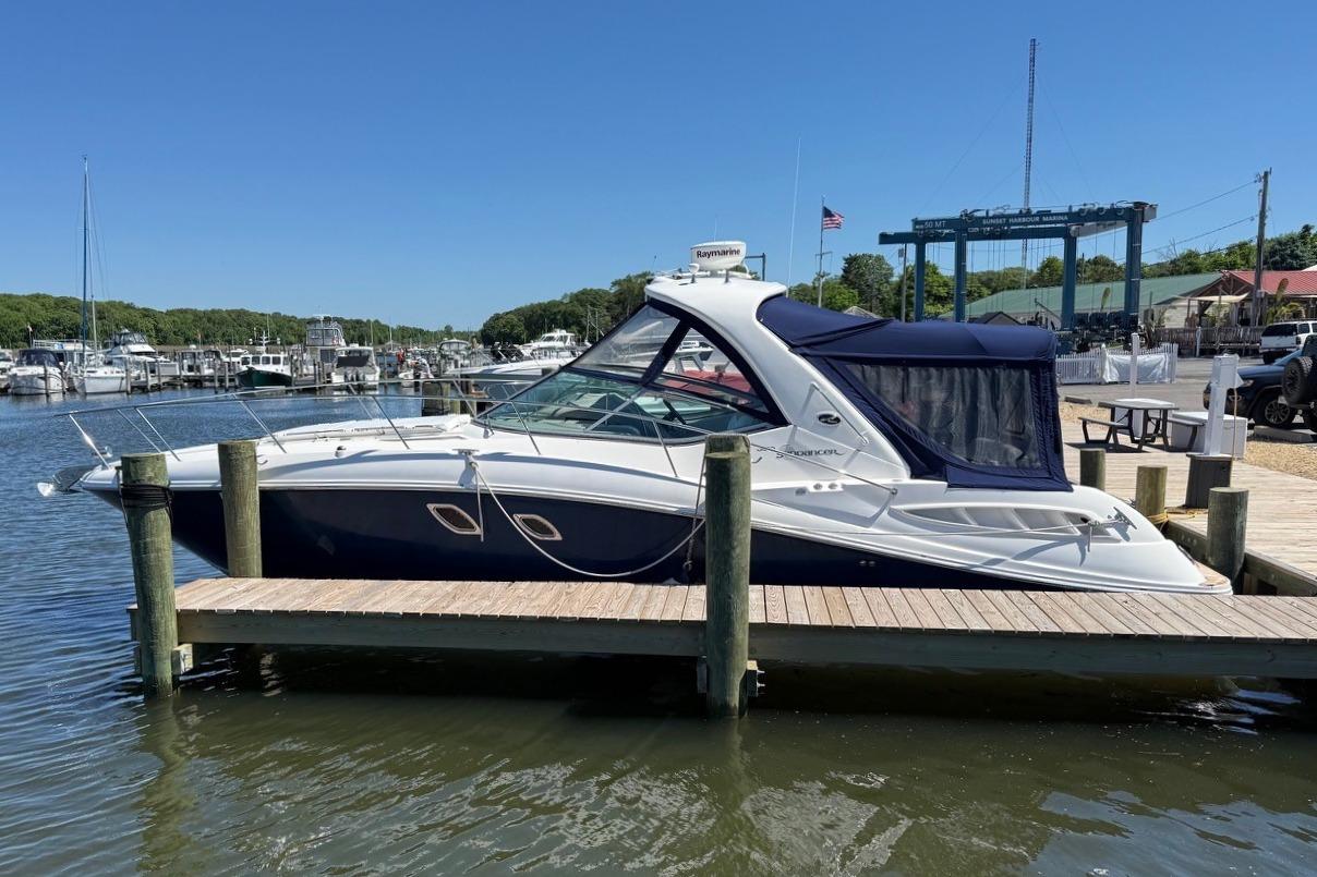2008 Sea Ray Sundancer 330 docked at a marina under clear blue skies.