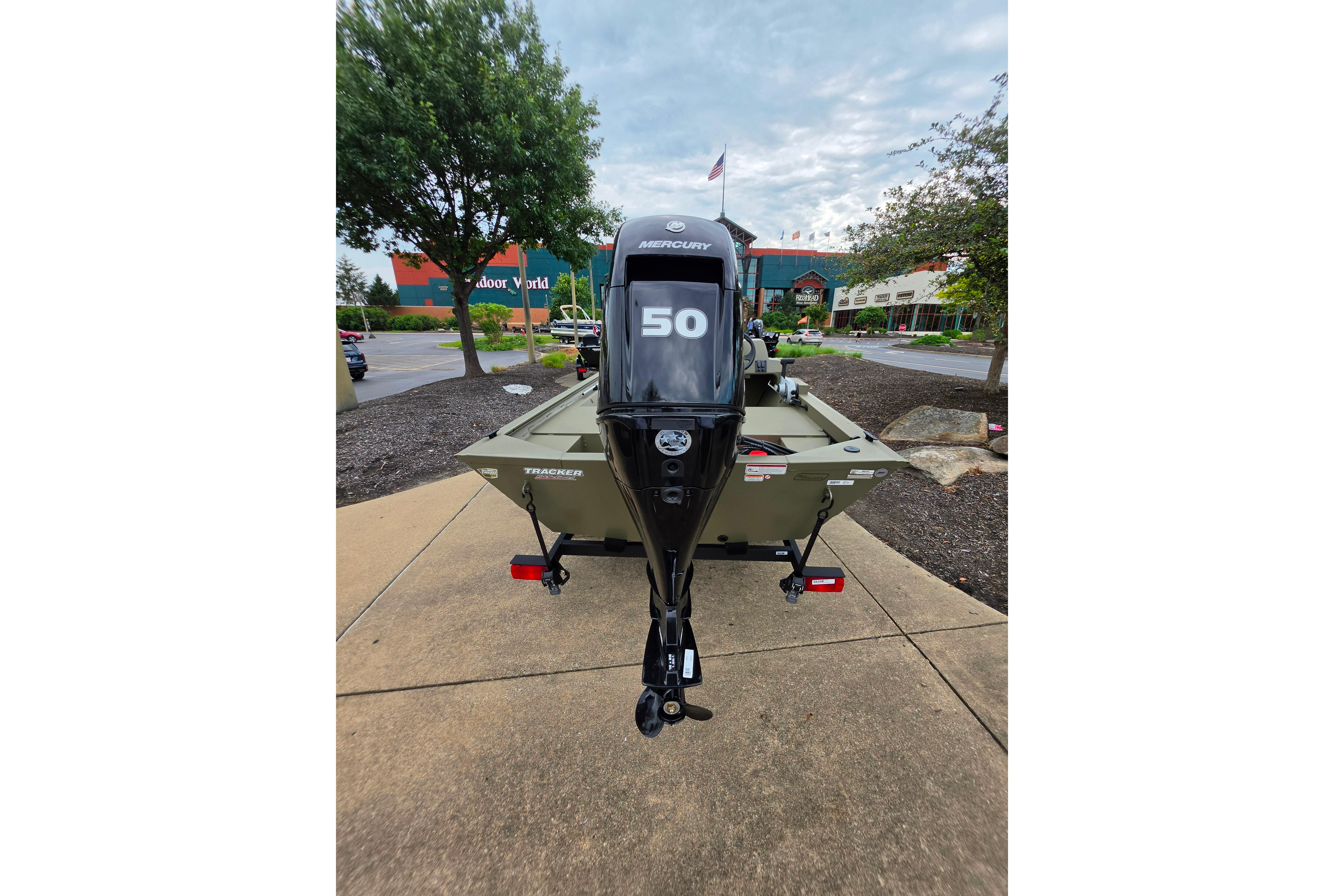 2026 Tracker Grizzly 1648 SC boat with Mercury 50 outboard motor, parked outdoors.