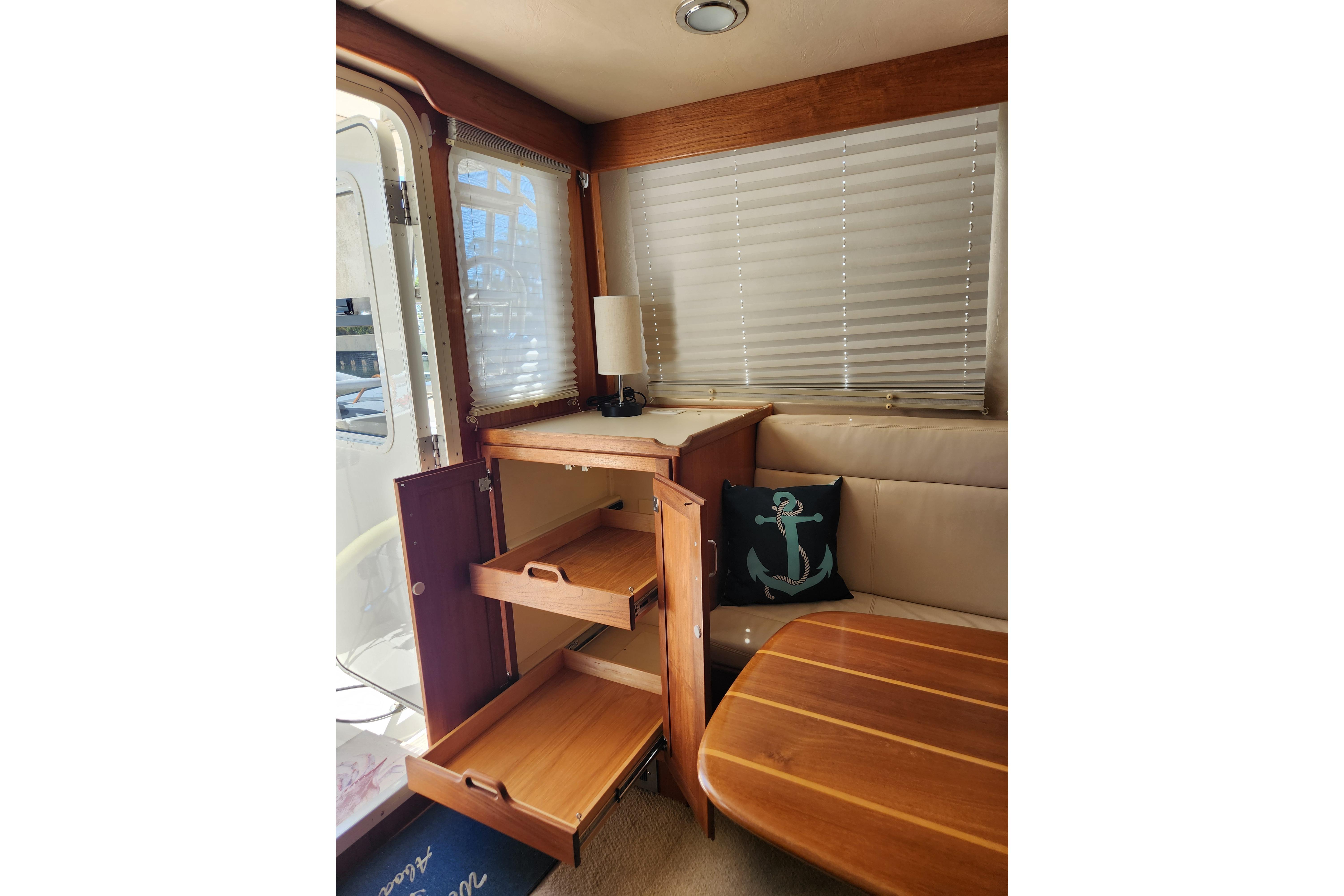 Interior of 2006 American Tug AT with wooden cabinetry and nautical-themed decor.