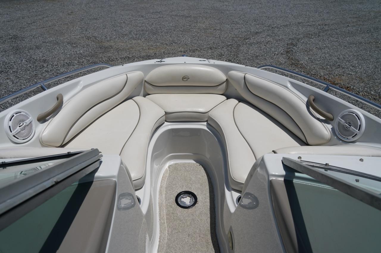 2004 Crownline 216 LS boat interior with white cushioned seating and speakers.