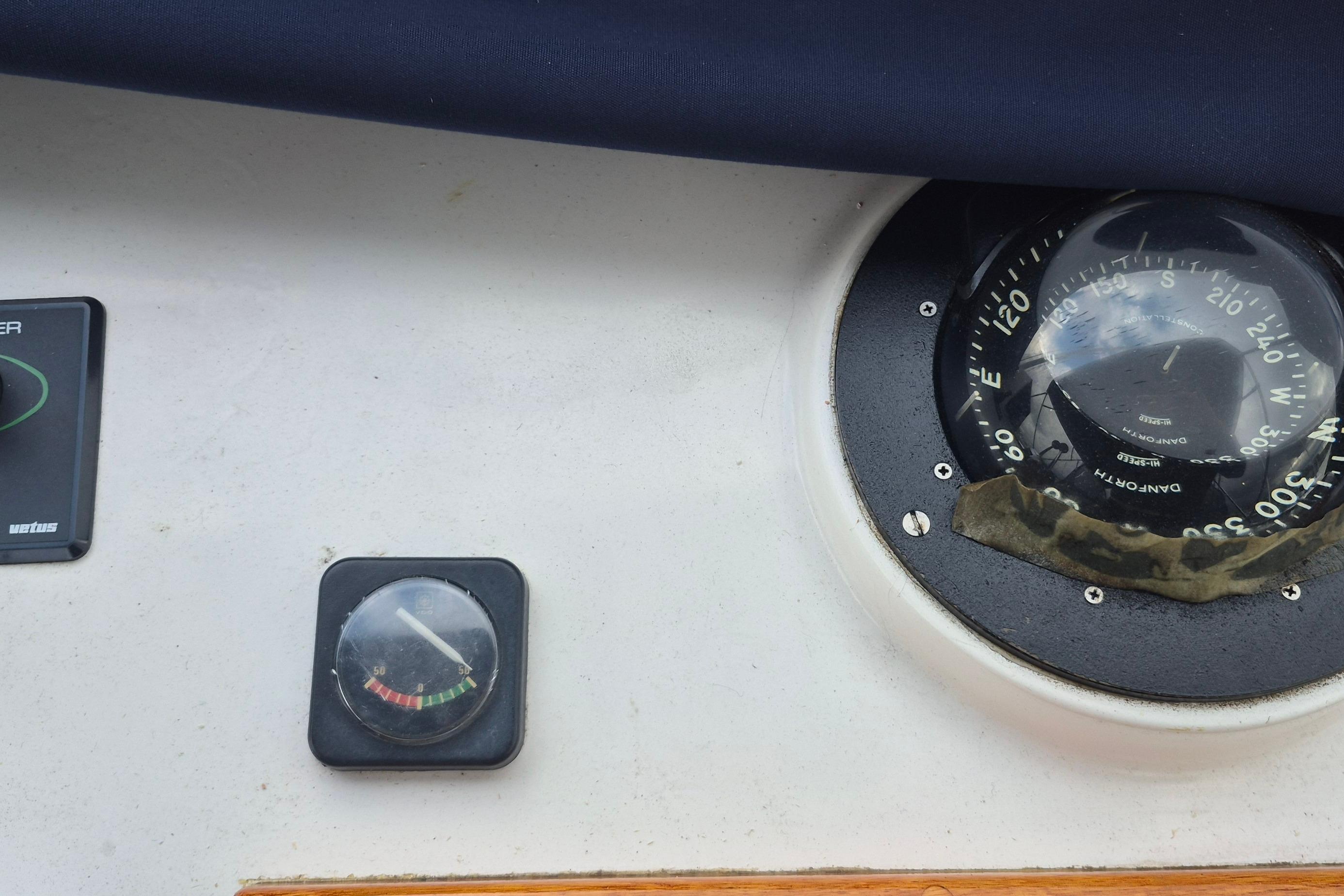 Compass and gauge on 1983 Grand Banks 42 Motoryacht dashboard.