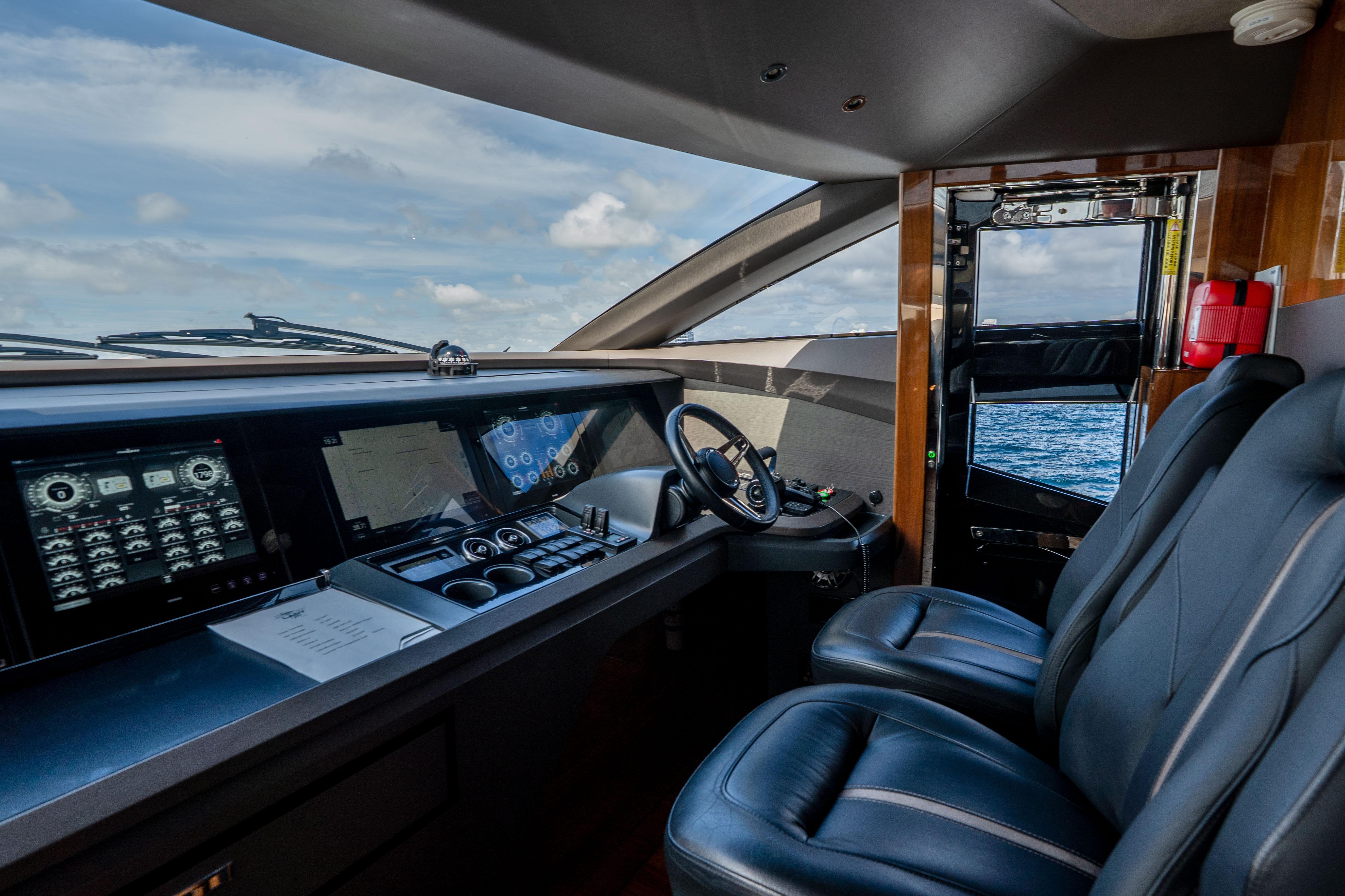 Luxurious 2020 Princess Y85 yacht cockpit with modern navigation controls and leather seating.
