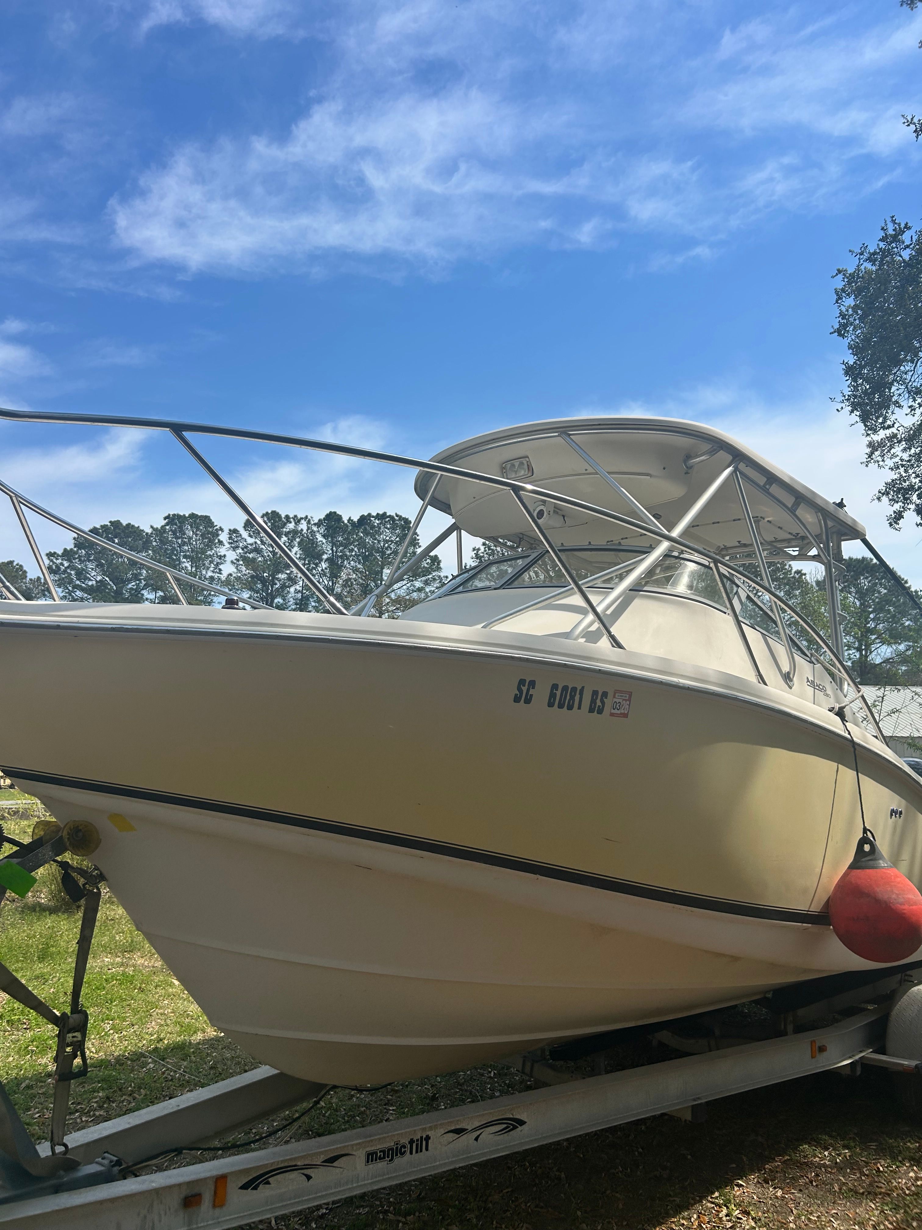 2003 Scout 280 Abaco on a trailer, featuring a hardtop and railing, under a blue sky.