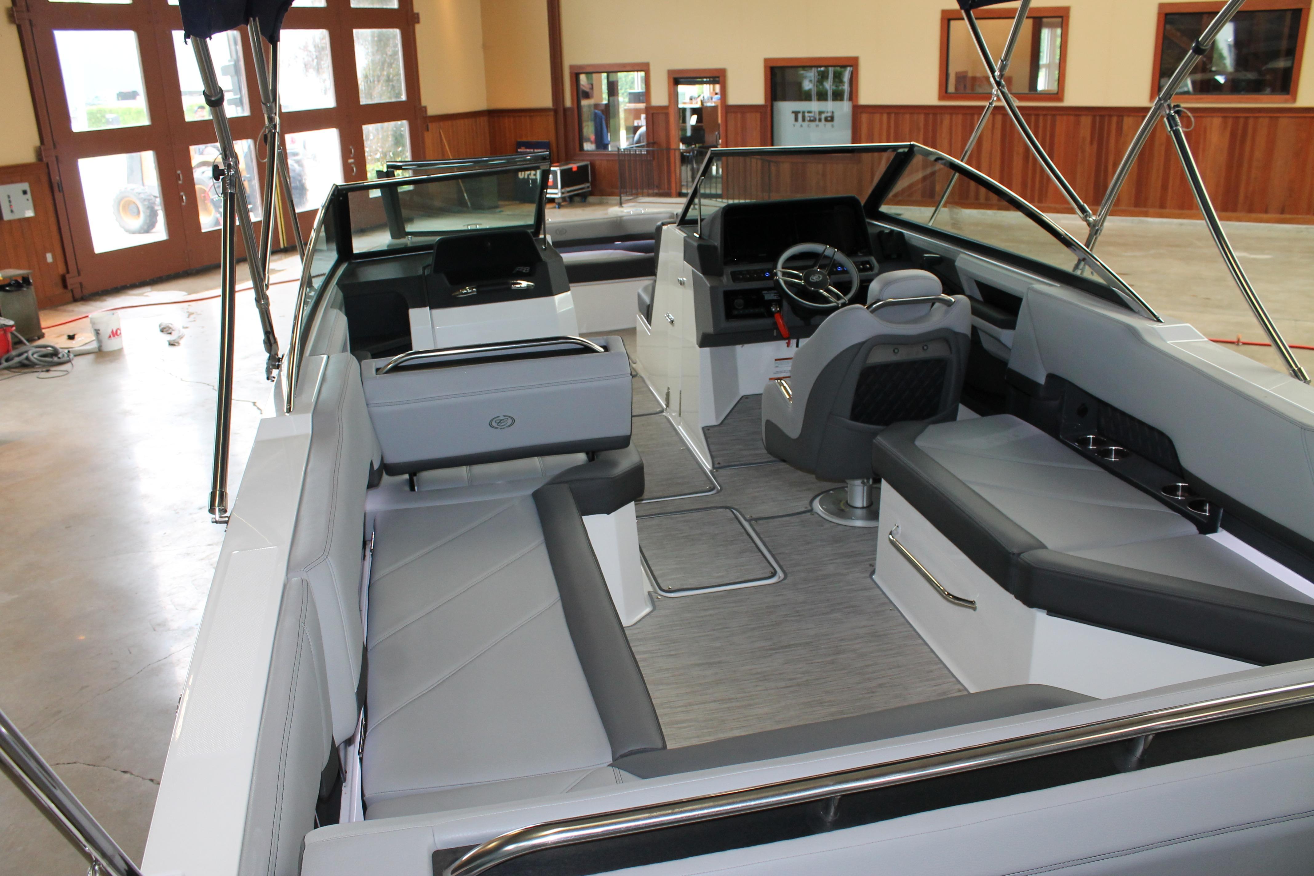 2023 Cobalt R8 boat interior with sleek seating and modern dashboard in a showroom.