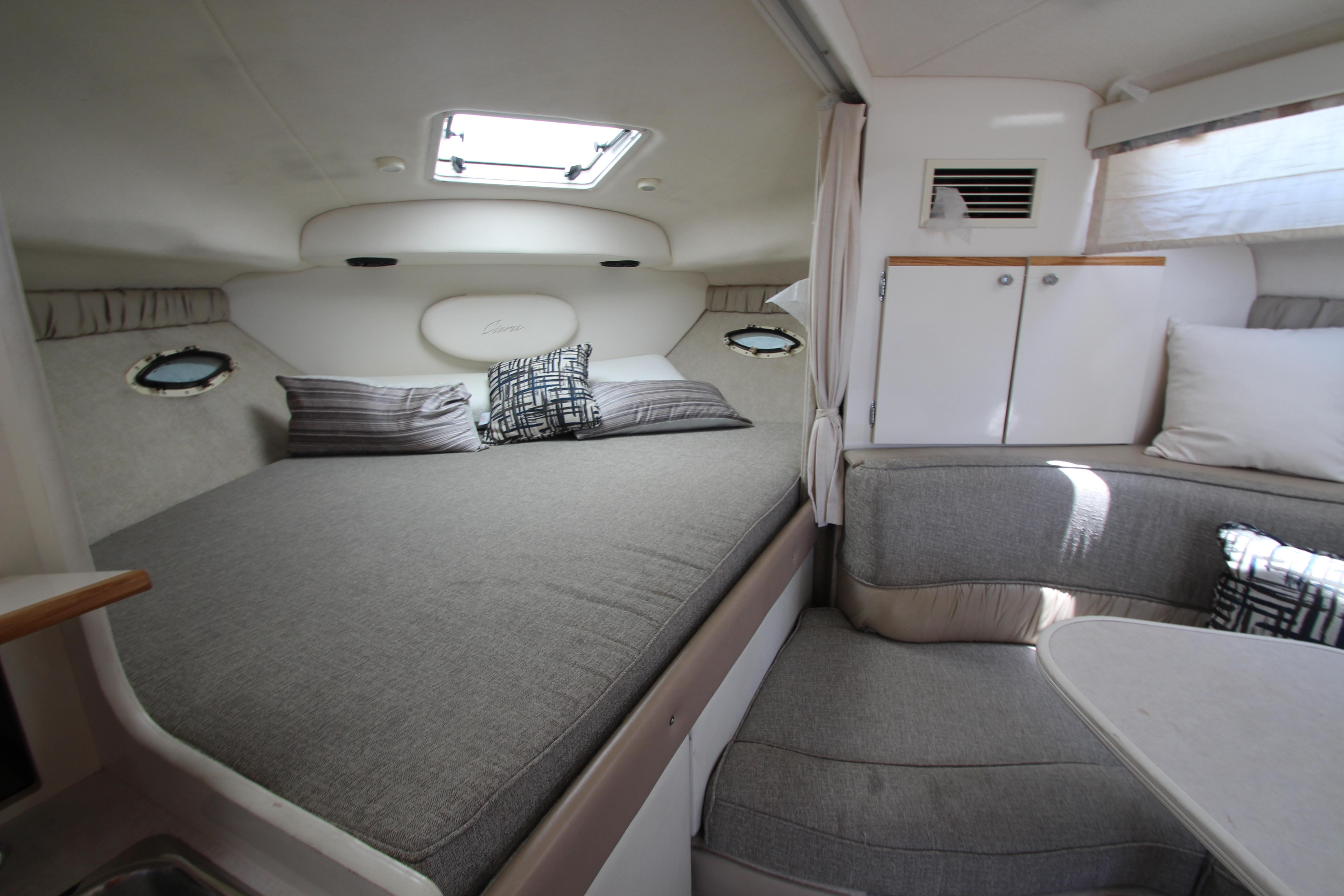 1999 Bayliner 3055 Ciera cabin interior with bed, seating, and storage.