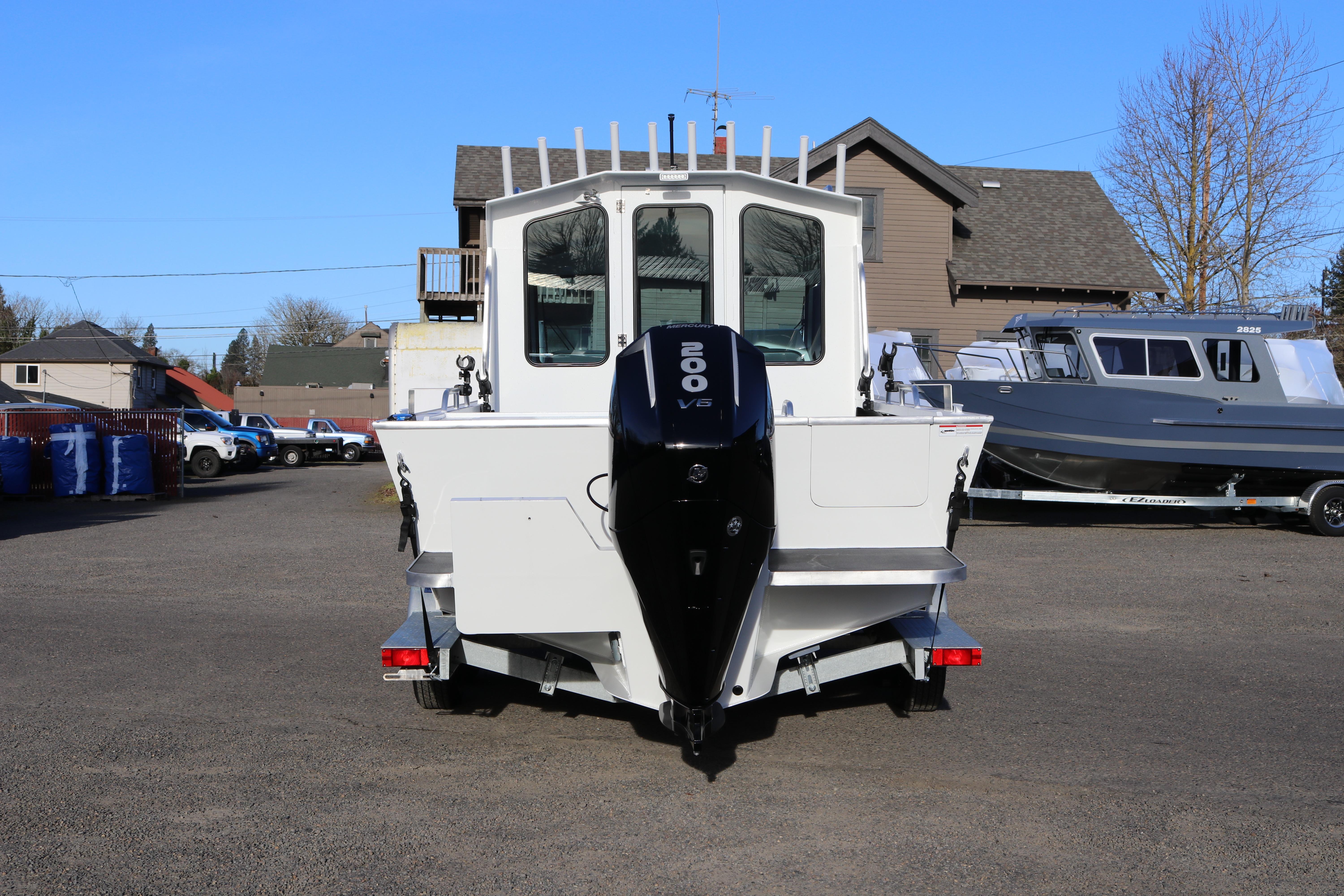 2026 Alumaweld Intruder Outboard 22 boat with 200 V6 engine, parked outdoors.
