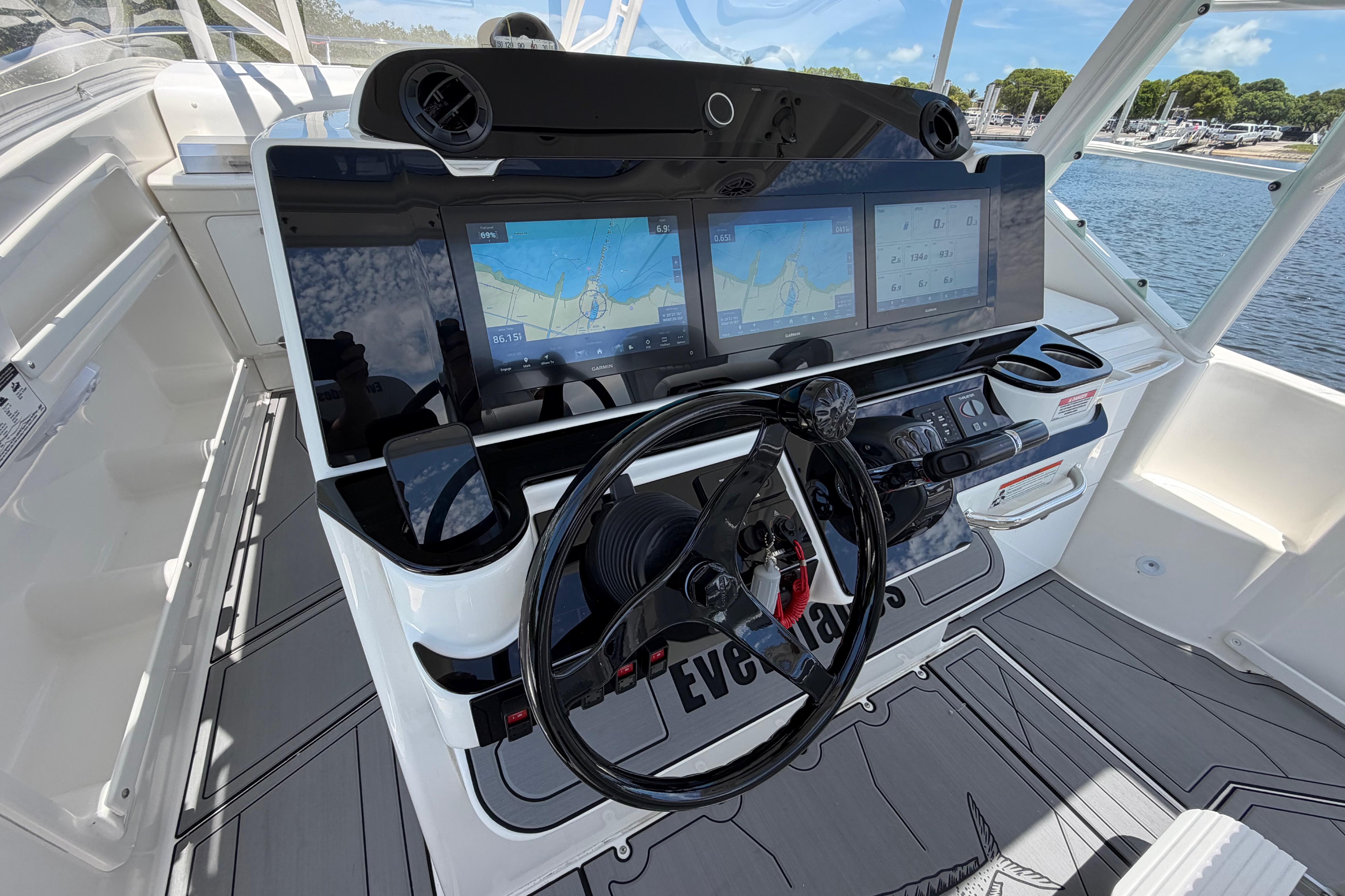 Cockpit of 2009 Everglades 350LX boat with advanced navigation displays and steering wheel.