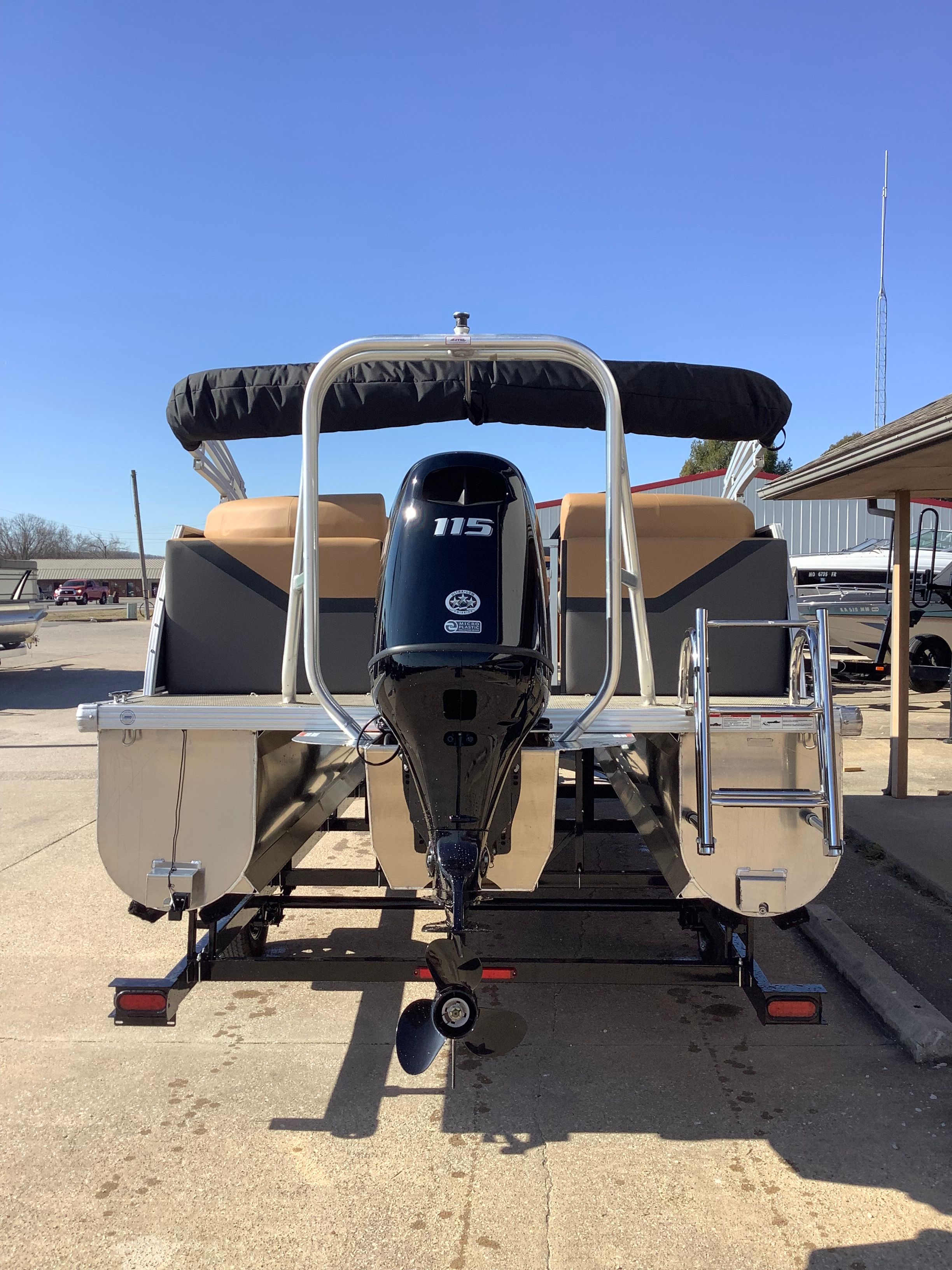 Rear view of a 2026 Landau 21 Island Breeze pontoon boat with outboard motor.