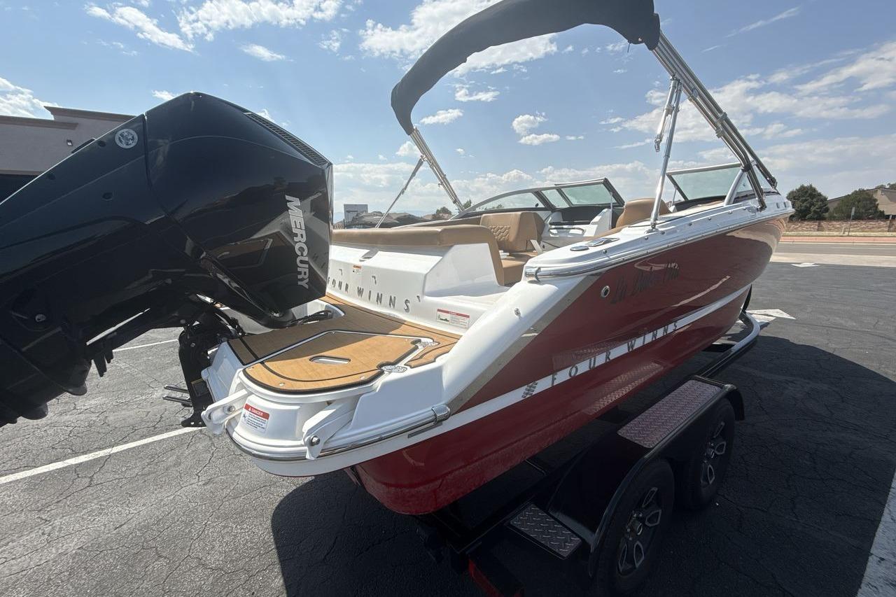 2024 Four Winns H1 OB boat with Mercury outboard engine on a trailer.