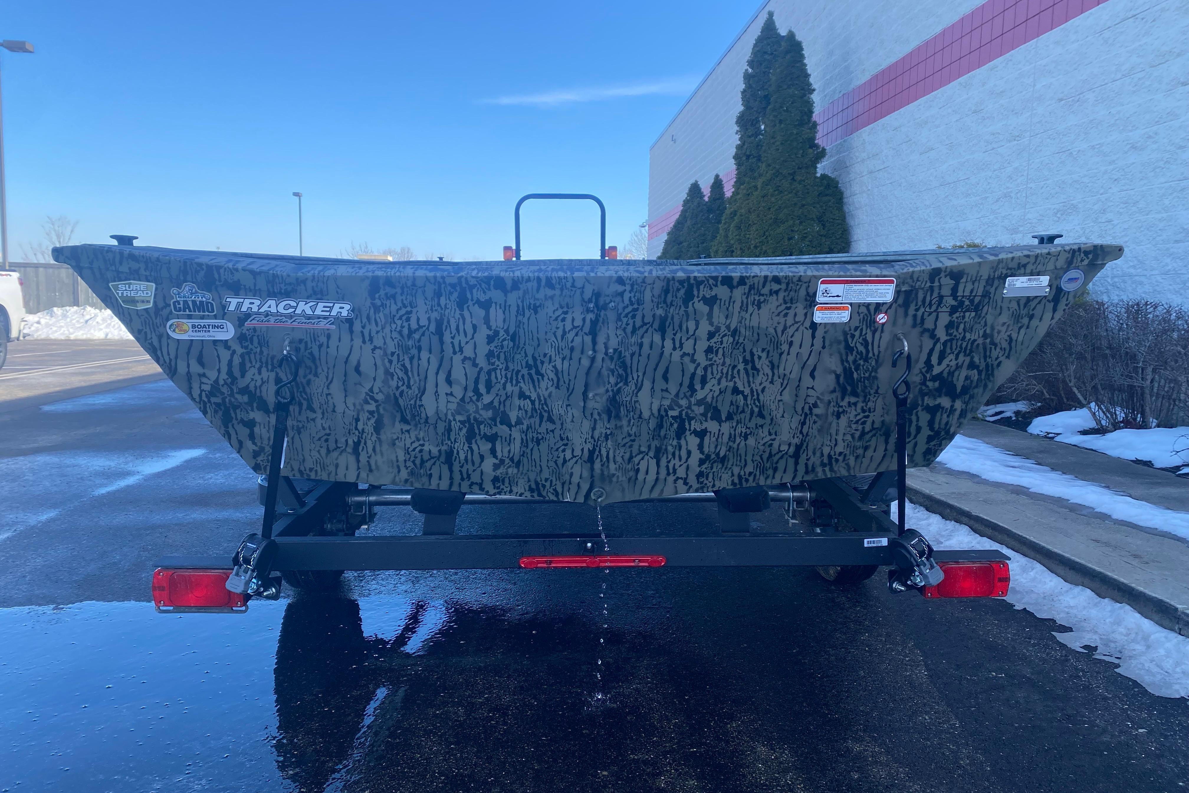2026 Tracker Grizzly 1860 Utility boat with camouflage design on a trailer.