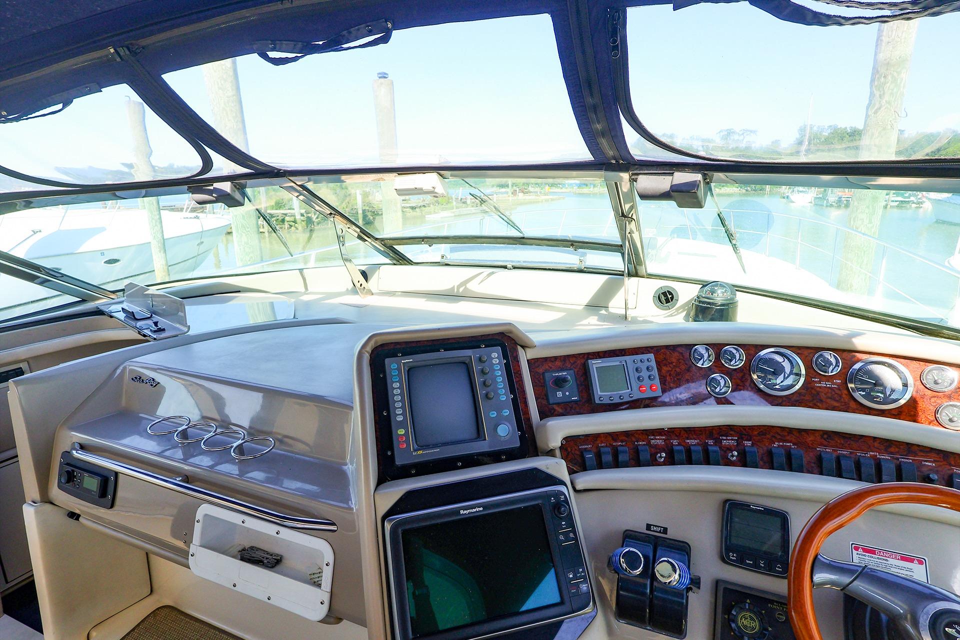 Cockpit view of 1998 Sea Ray 500 Sundancer yacht with navigation instruments and steering wheel.