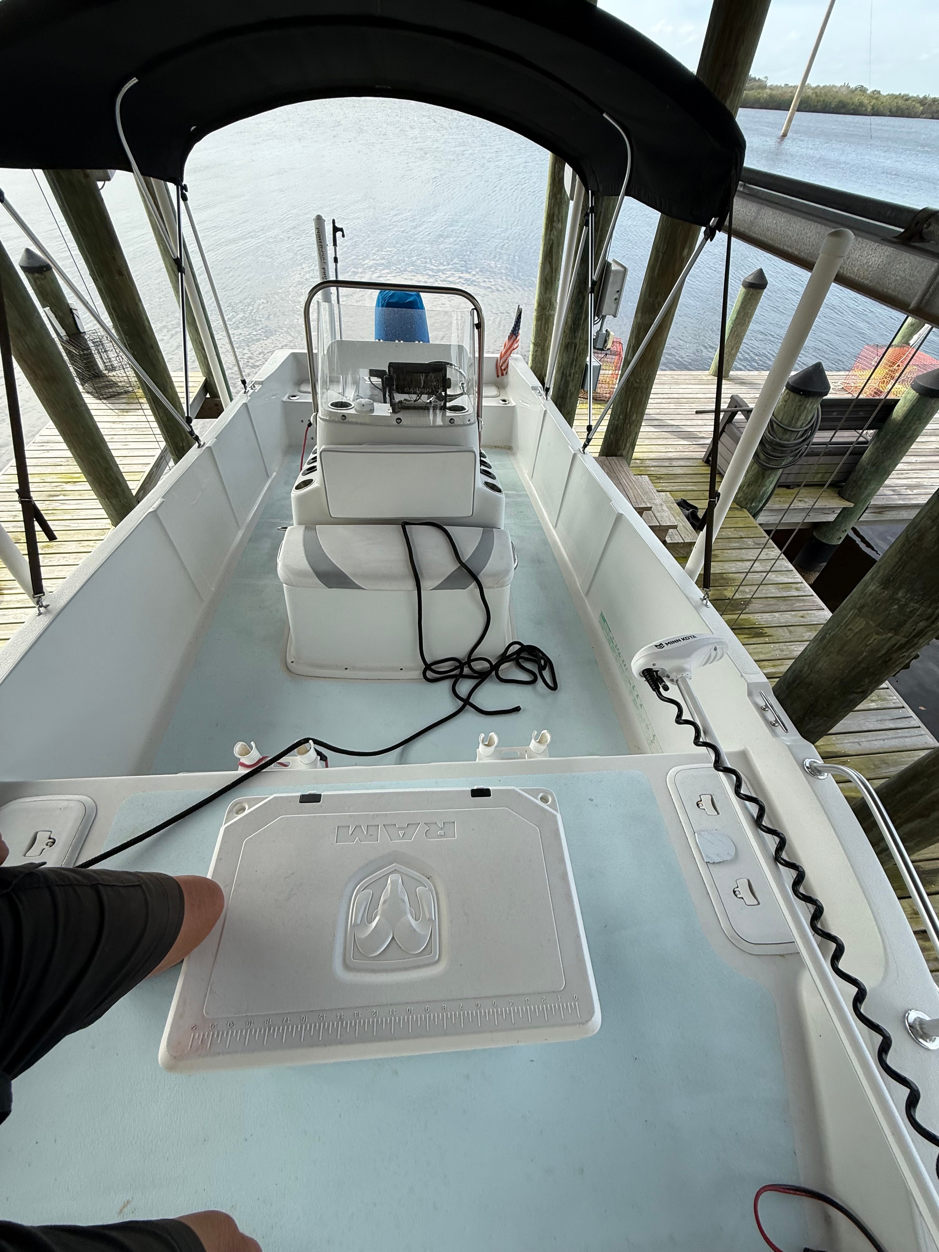 A 2011 Carolina Cat 18CC boat docked, overlooking the water.