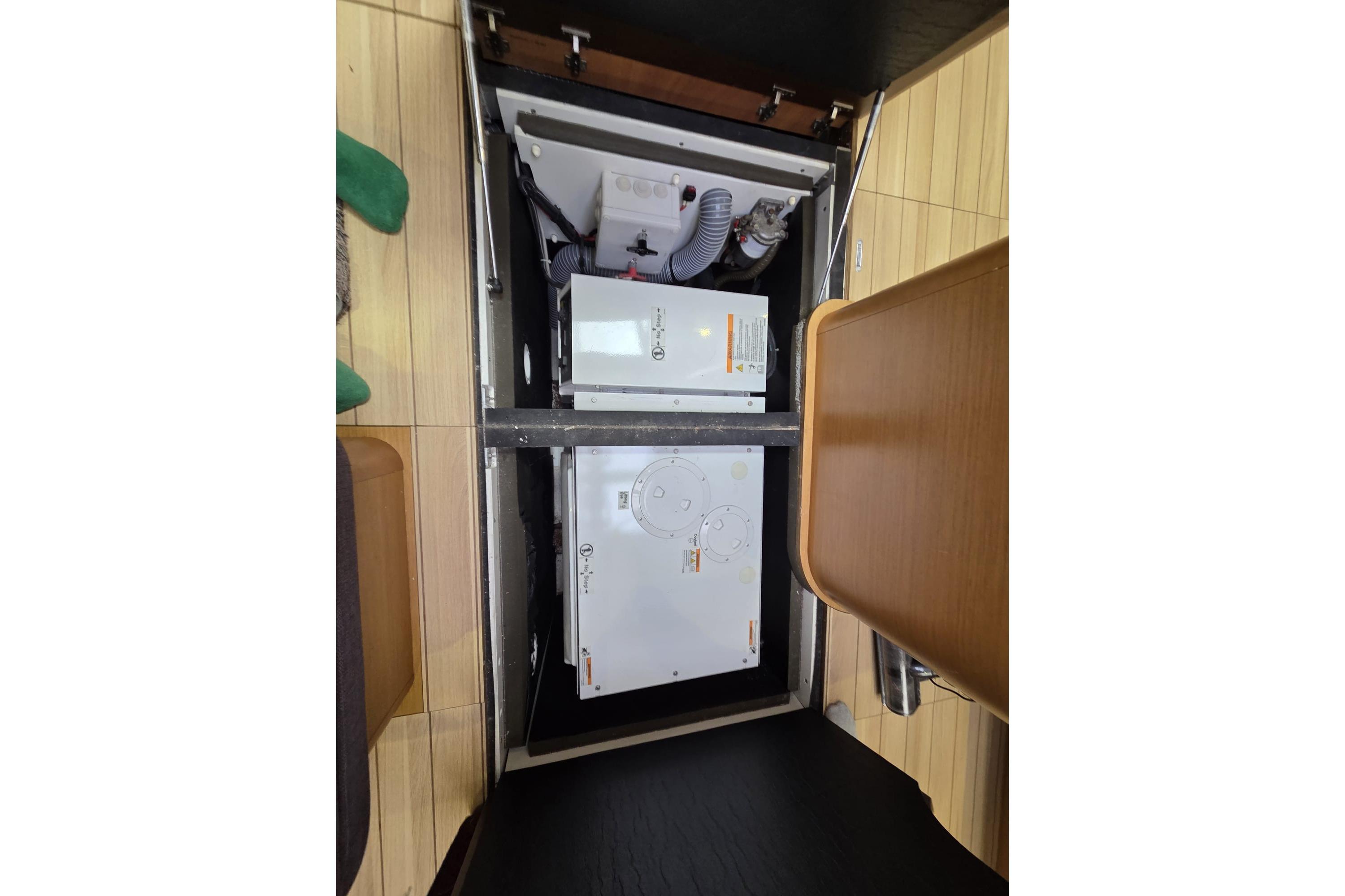 Engine compartment of a 2015 Jeanneau 57 yacht, showcasing mechanical components.