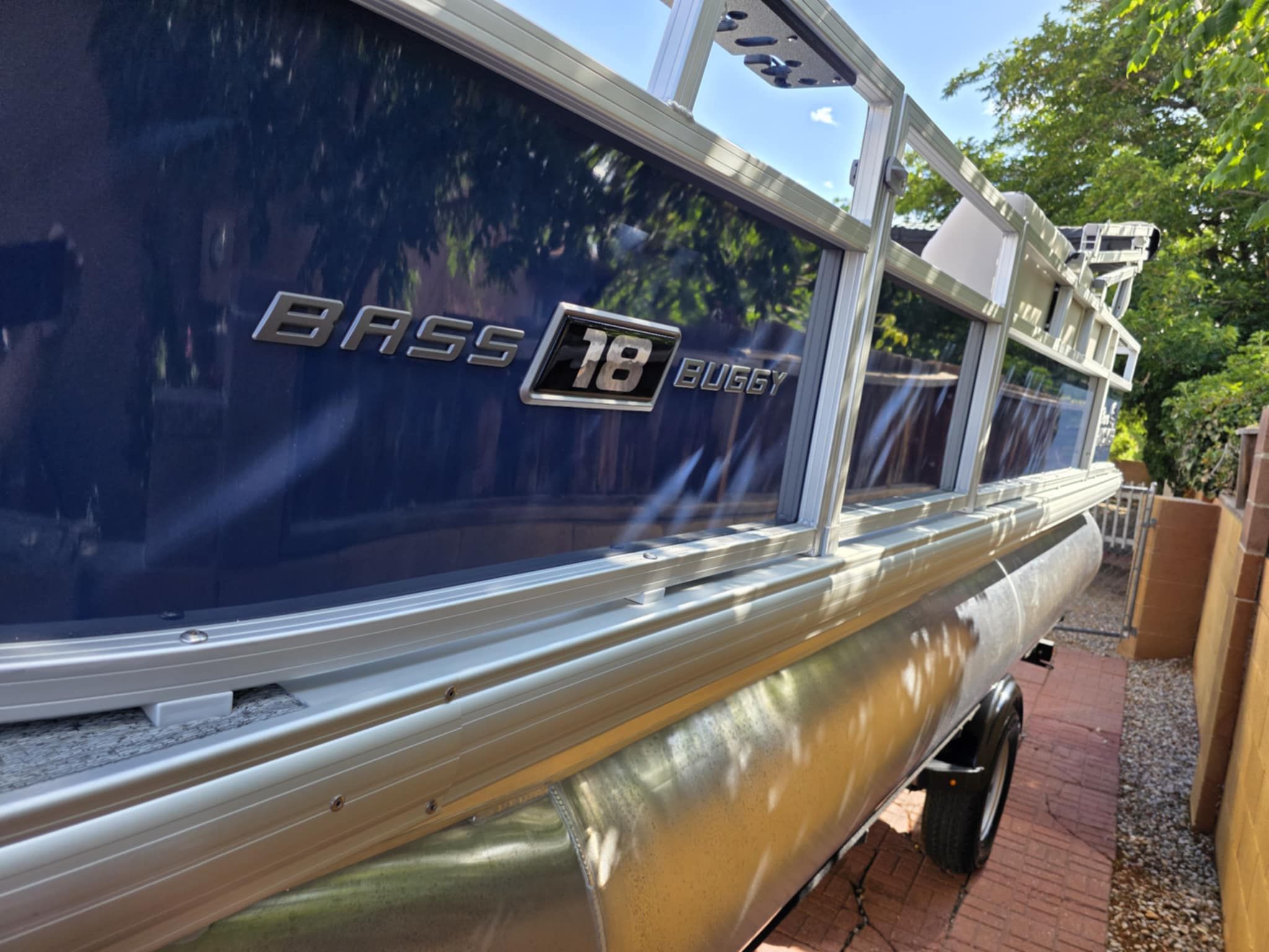 A 2026 Sun Tracker Bass Buggy 18 DLX is parked on a trailer outdoors.