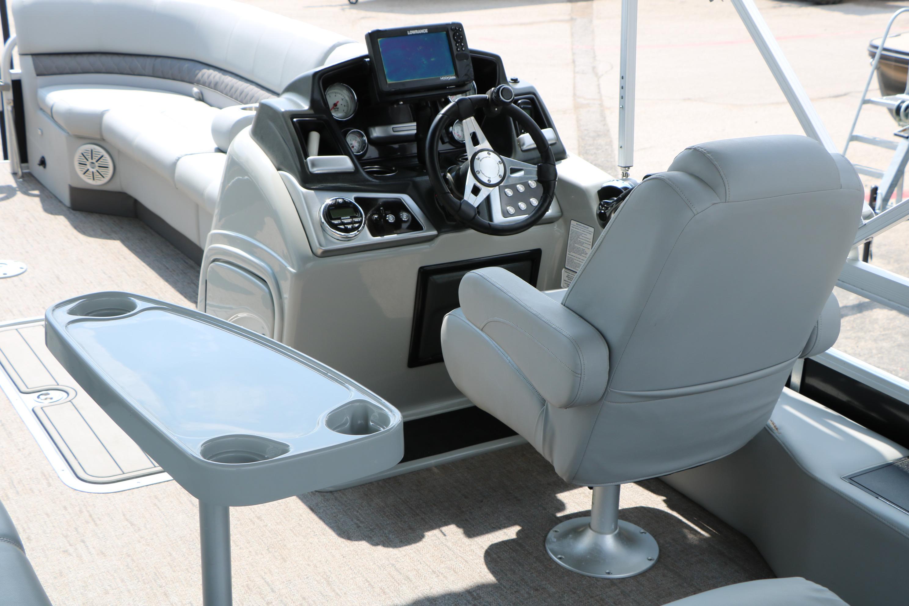 2021 Ranger 223FC boat interior with steering console, seating, and table.