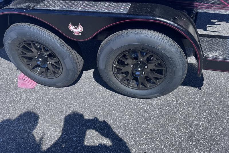 Black wheels on a 2026 Phoenix 819 ZXL trailer, parked on asphalt.