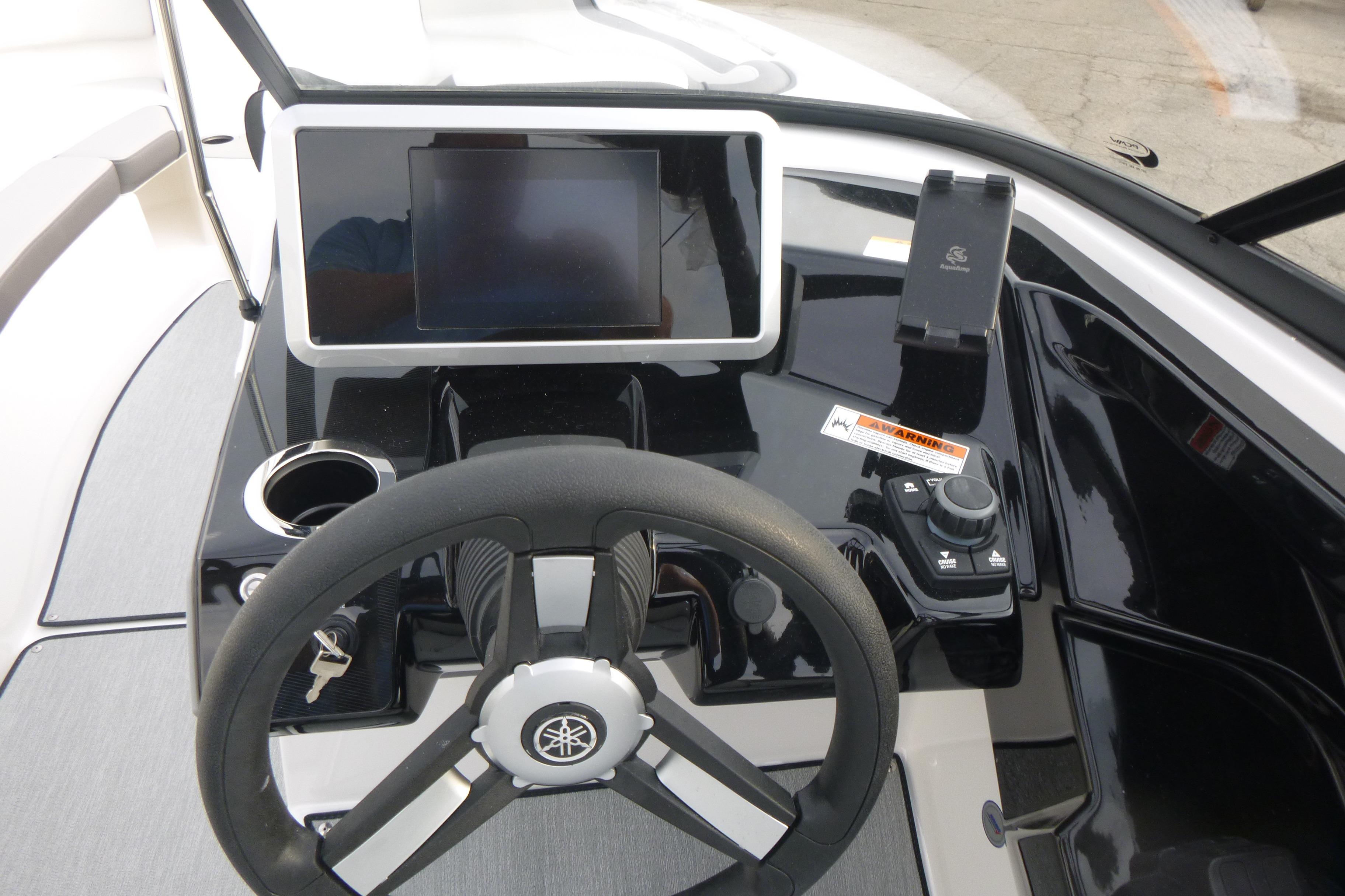 2026 Yamaha Boats AR250 dashboard with steering wheel, touchscreen, and controls.