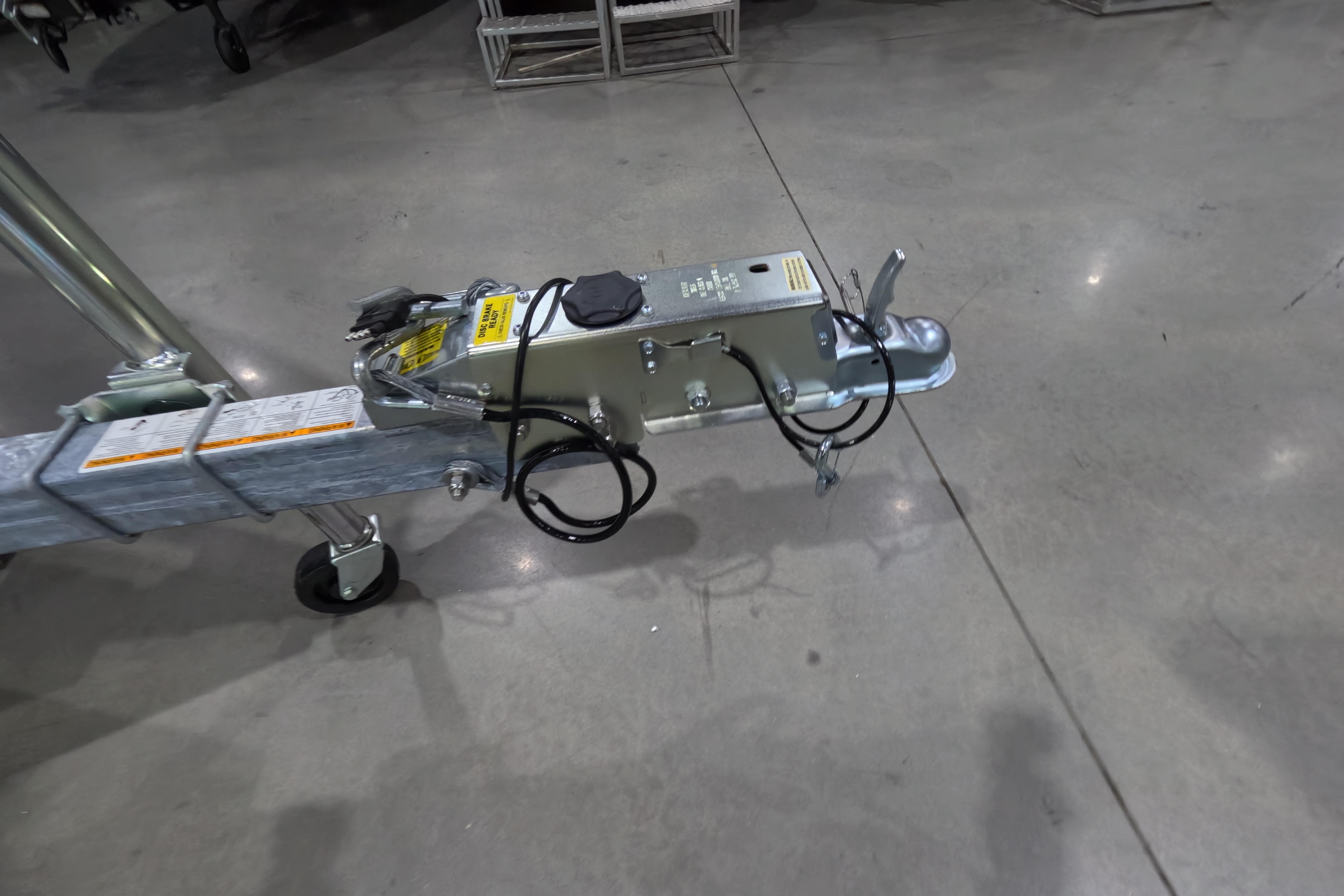 Trailer hitch assembly on a 2026 Skeeter, displayed on a polished concrete floor.