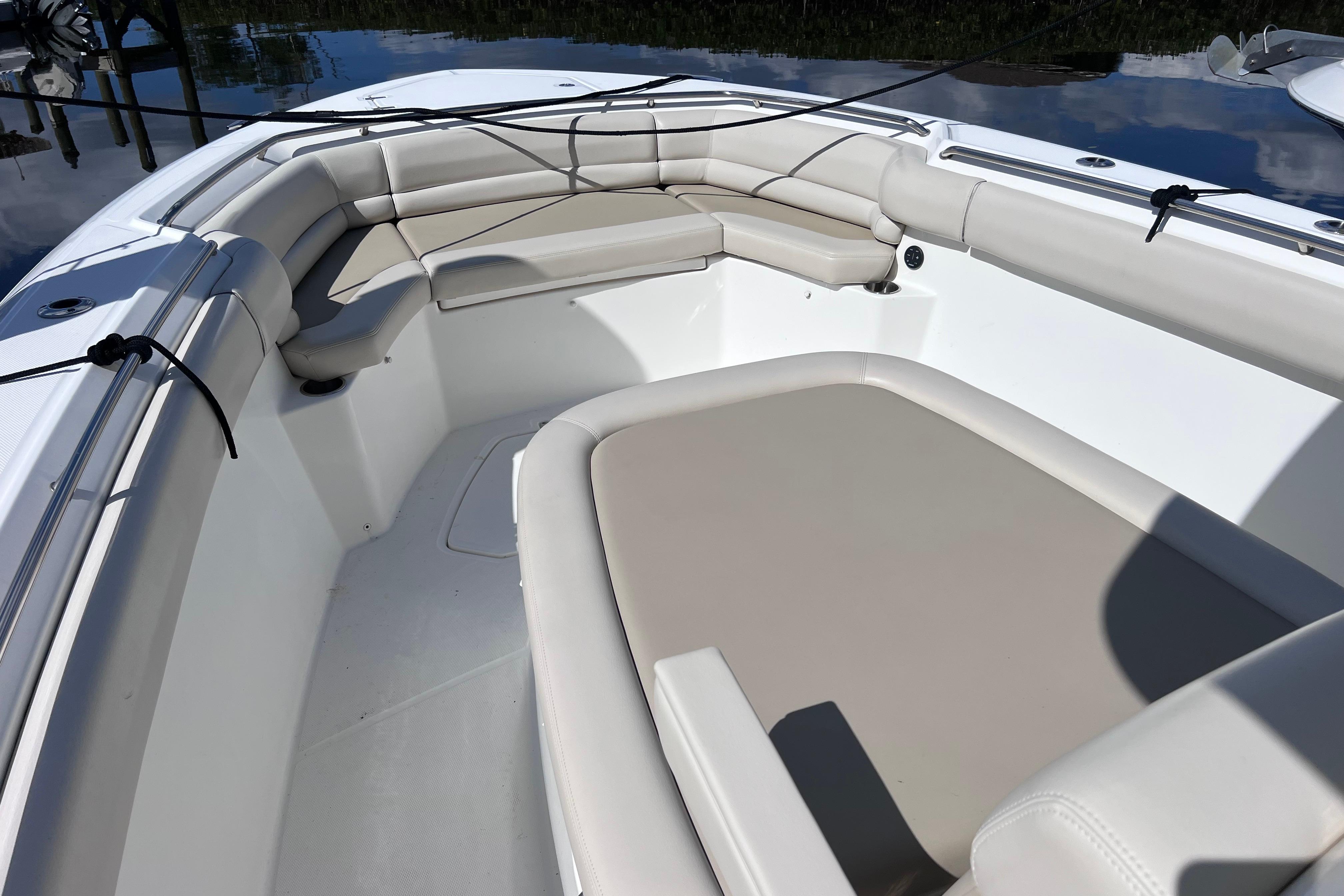 2021 Boston Whaler 330 Outrage boat interior with cushioned seating.
