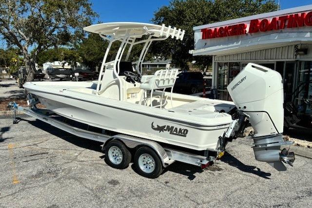 2026 Mako 24 APEX boat on trailer, parked outside Tracker Boating Center.