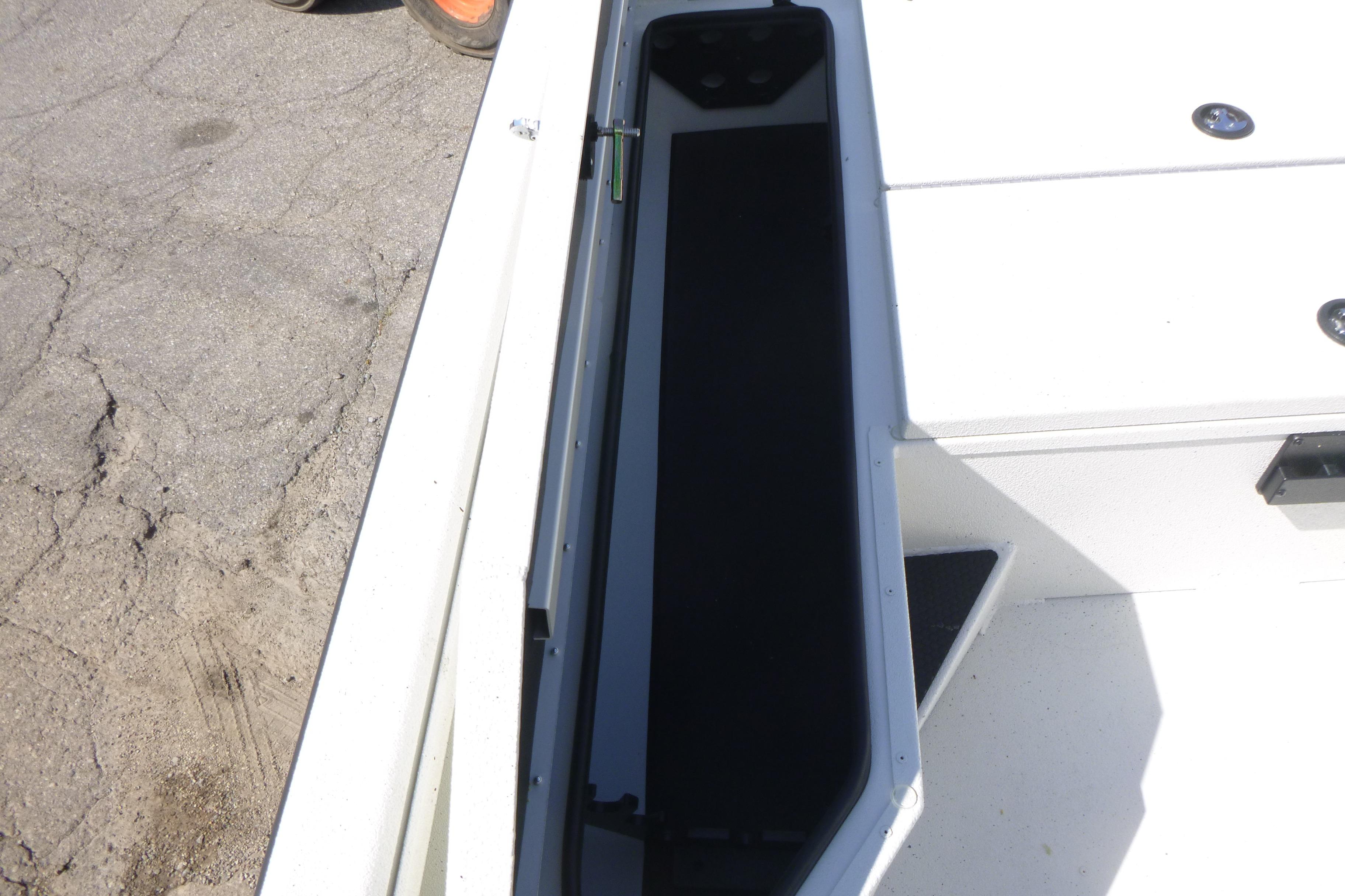 2025 Ranger RB210 boat storage compartment with open lid on a sunny day.