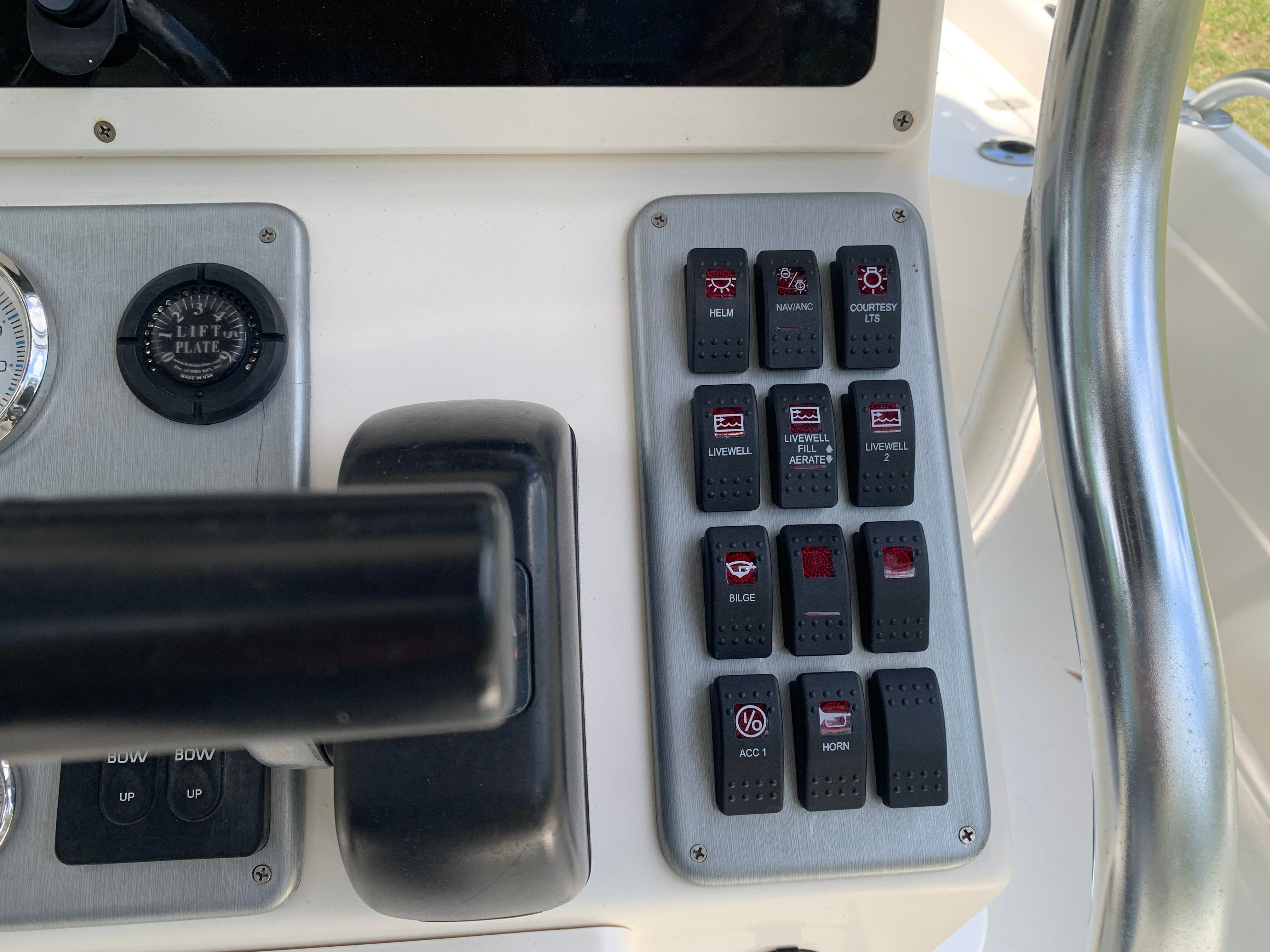 Control panel of a 2007 ShearWater 23 LTZ boat with various switches.