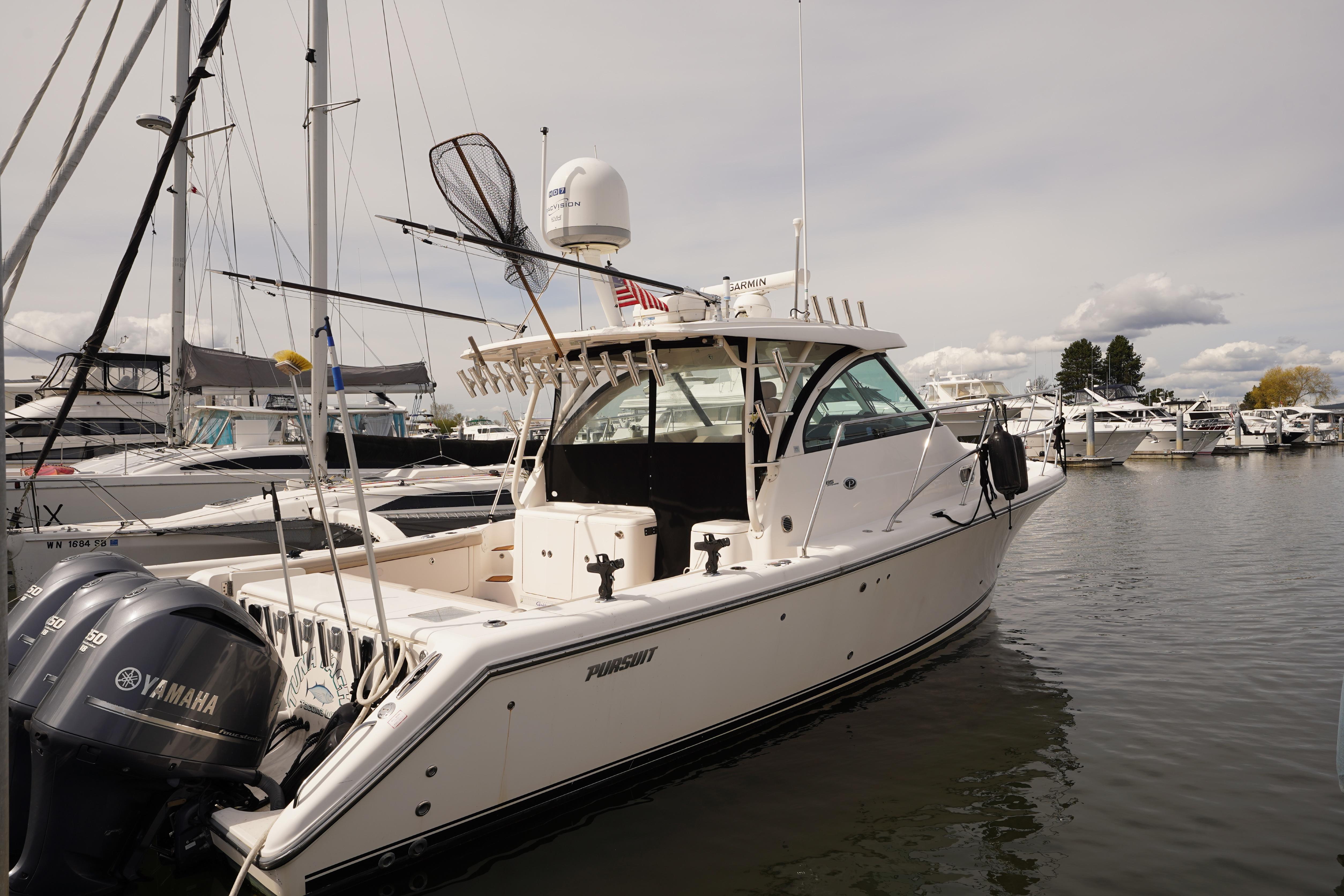 2015 Pursuit OS 385 Offshore boat docked with Yamaha engines, surrounded by other vessels.