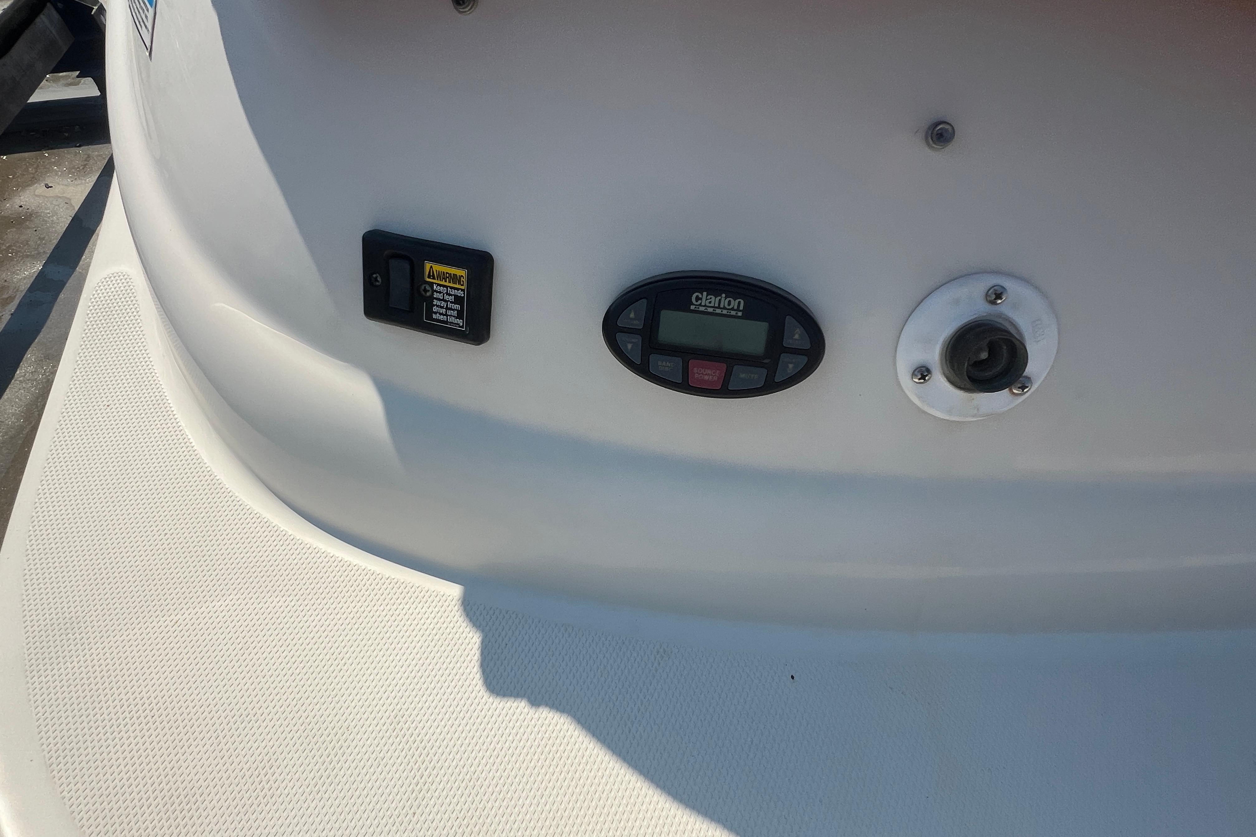 Control panel on a 2005 Sea Ray 240 Sundeck boat, featuring Clarion audio system.