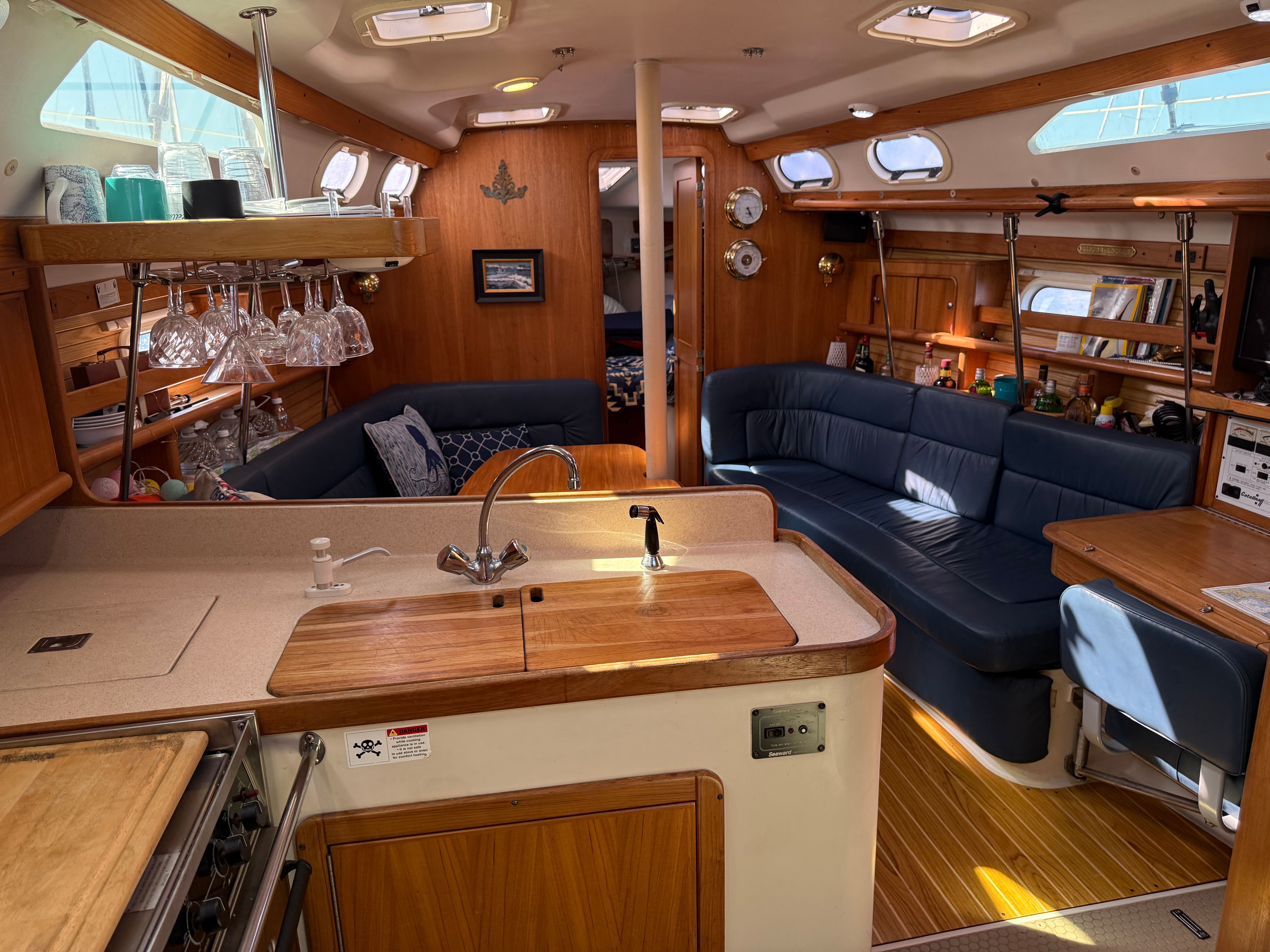 Interior of a 2003 Catalina 380 yacht with kitchen and seating area.