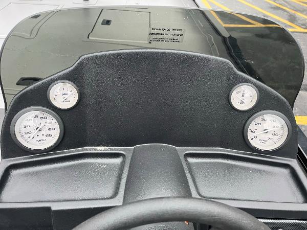 Dashboard of 2024 Lowe Legacy boat with gauges and steering wheel.