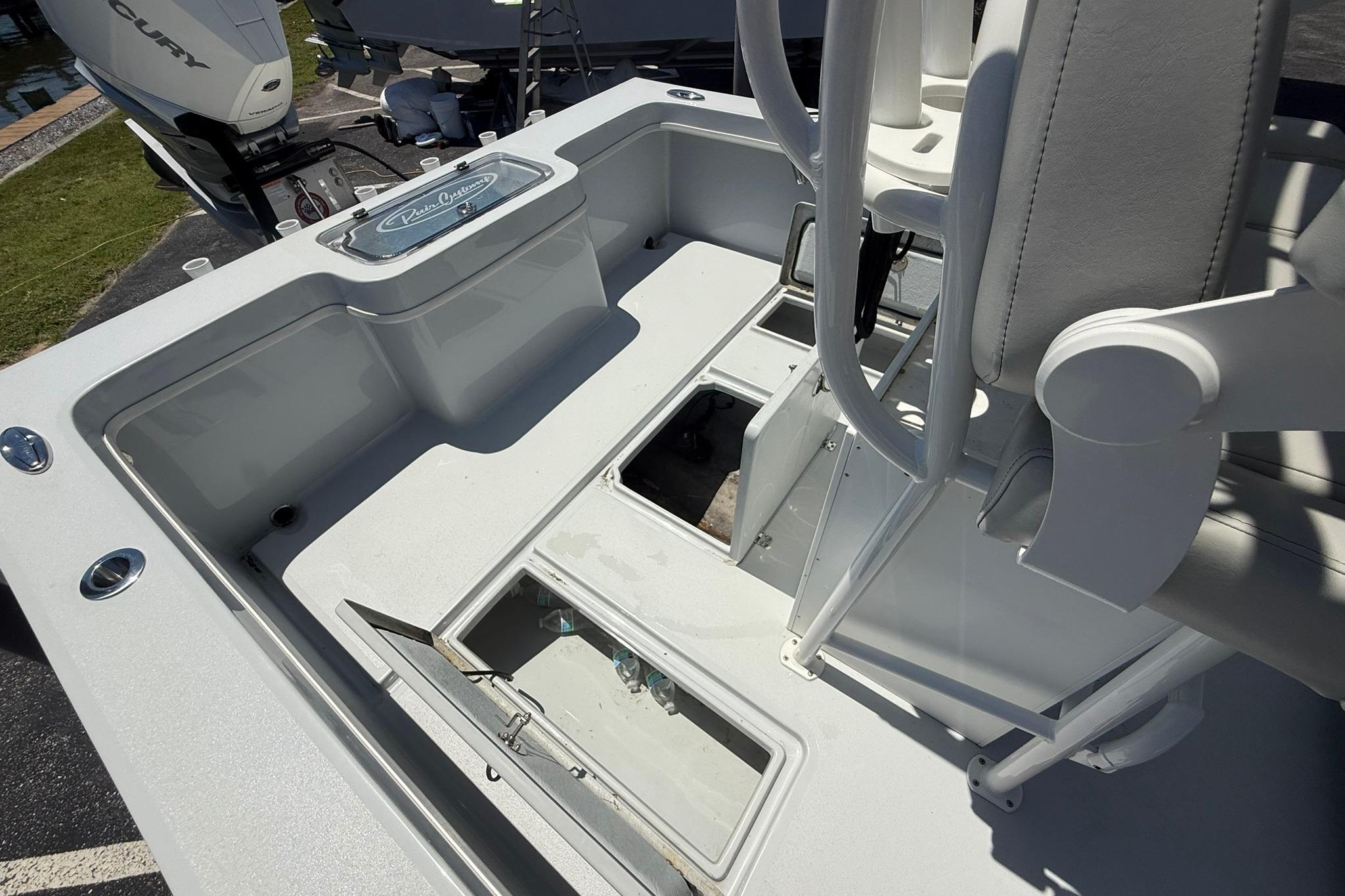 2024 Pair Customs 24 Center Console MV boat interior with storage compartments and seating.