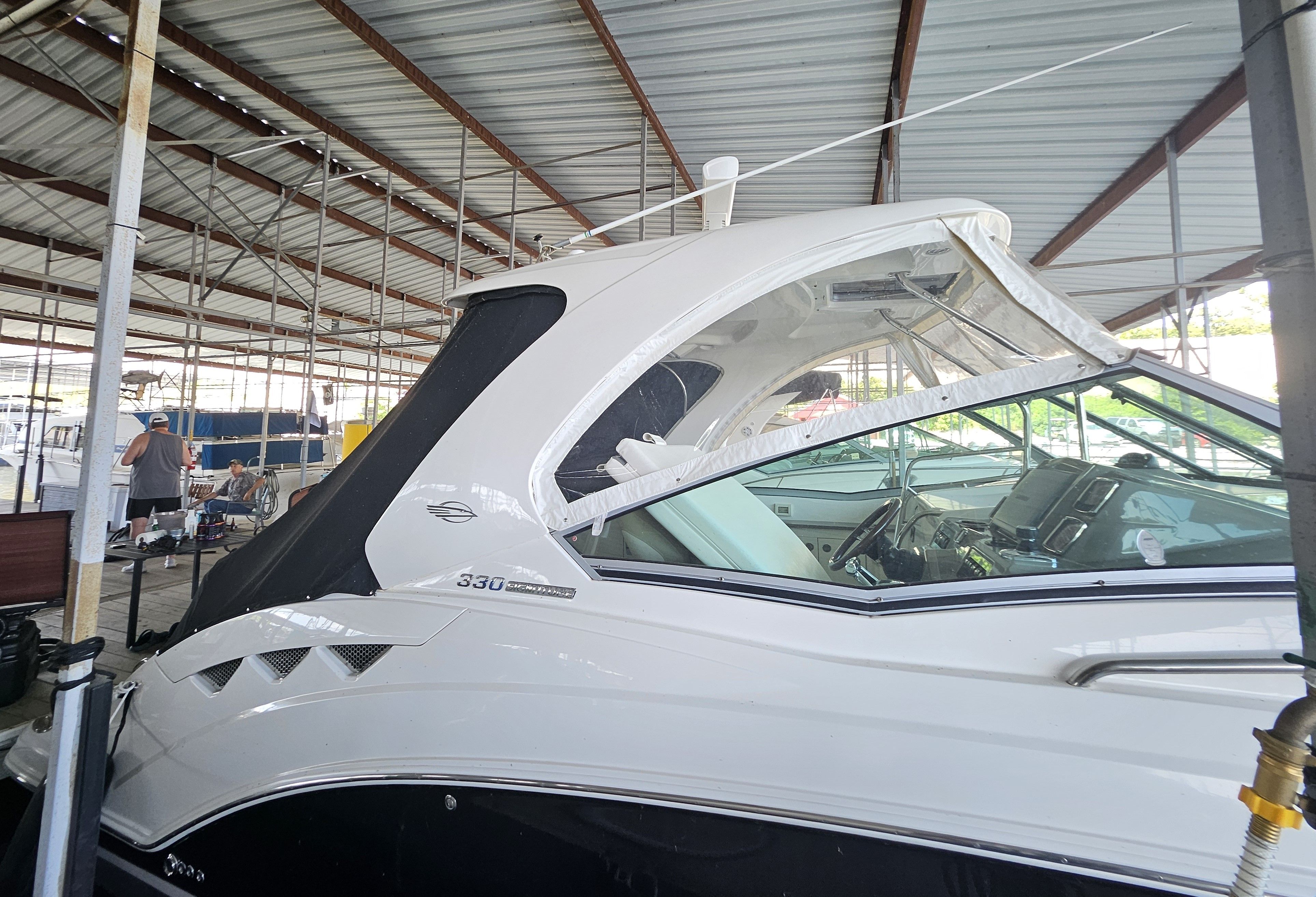 2014 Chaparral 330 Signature Yacht in covered dock.
