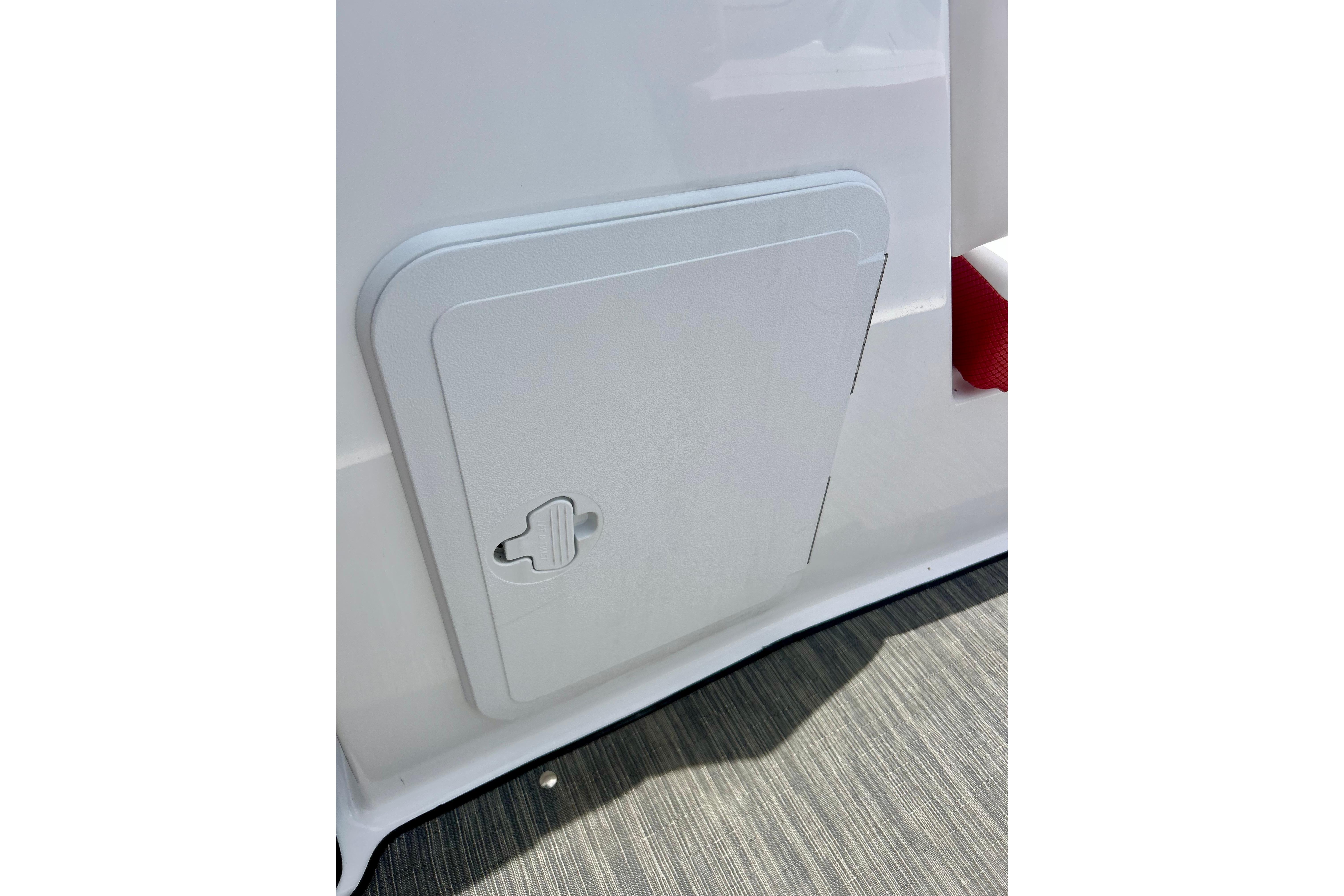 Access panel on 2021 Scarab 195 ID boat, featuring sleek white design.