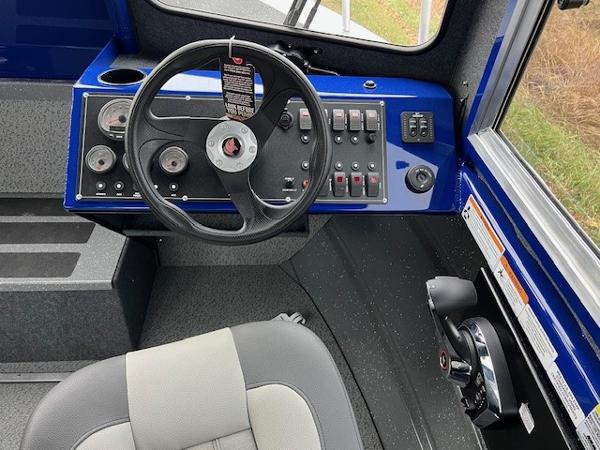 2023 Spartan 220 Maximus Pro dashboard with steering wheel and control panel.