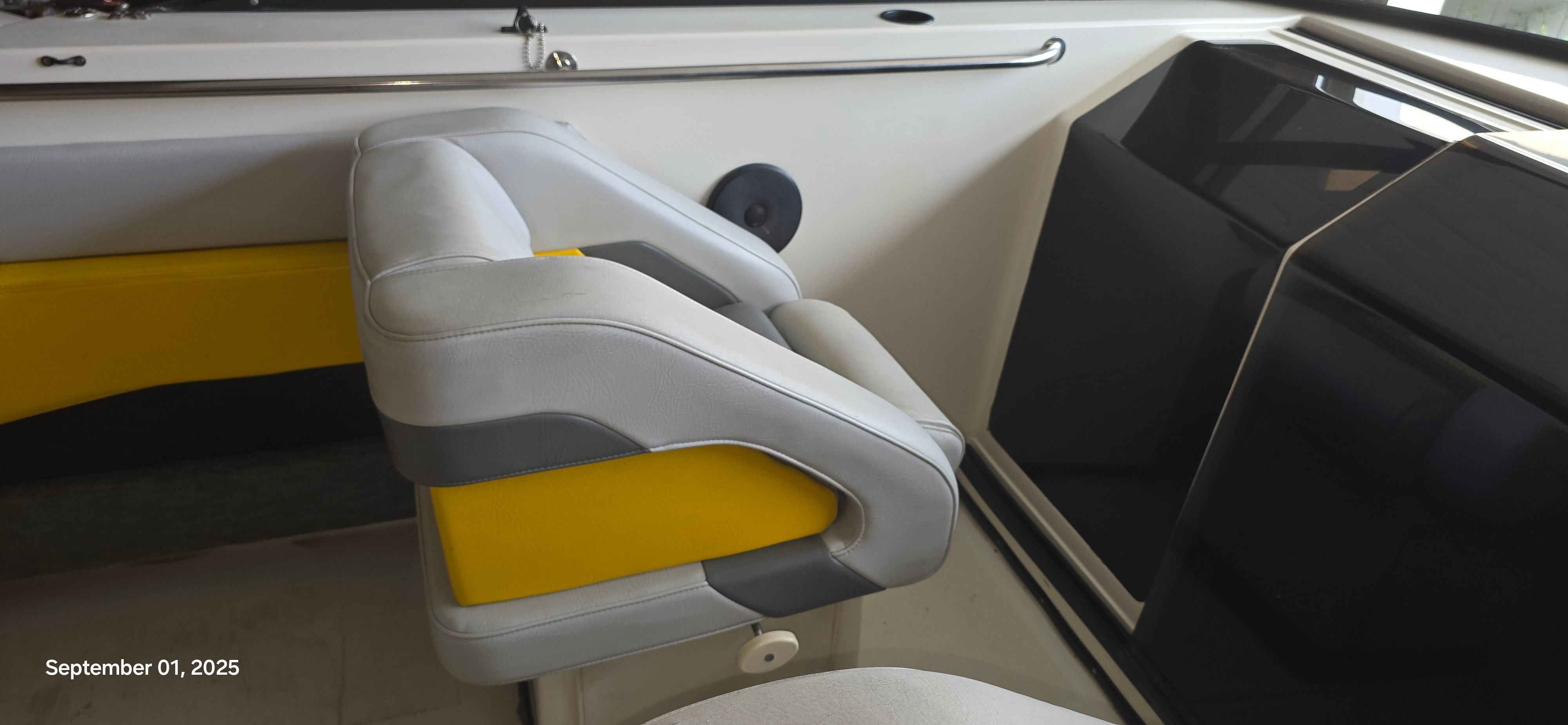 Interior of a 1989 Baja FORCE 235 boat with yellow and gray seating.