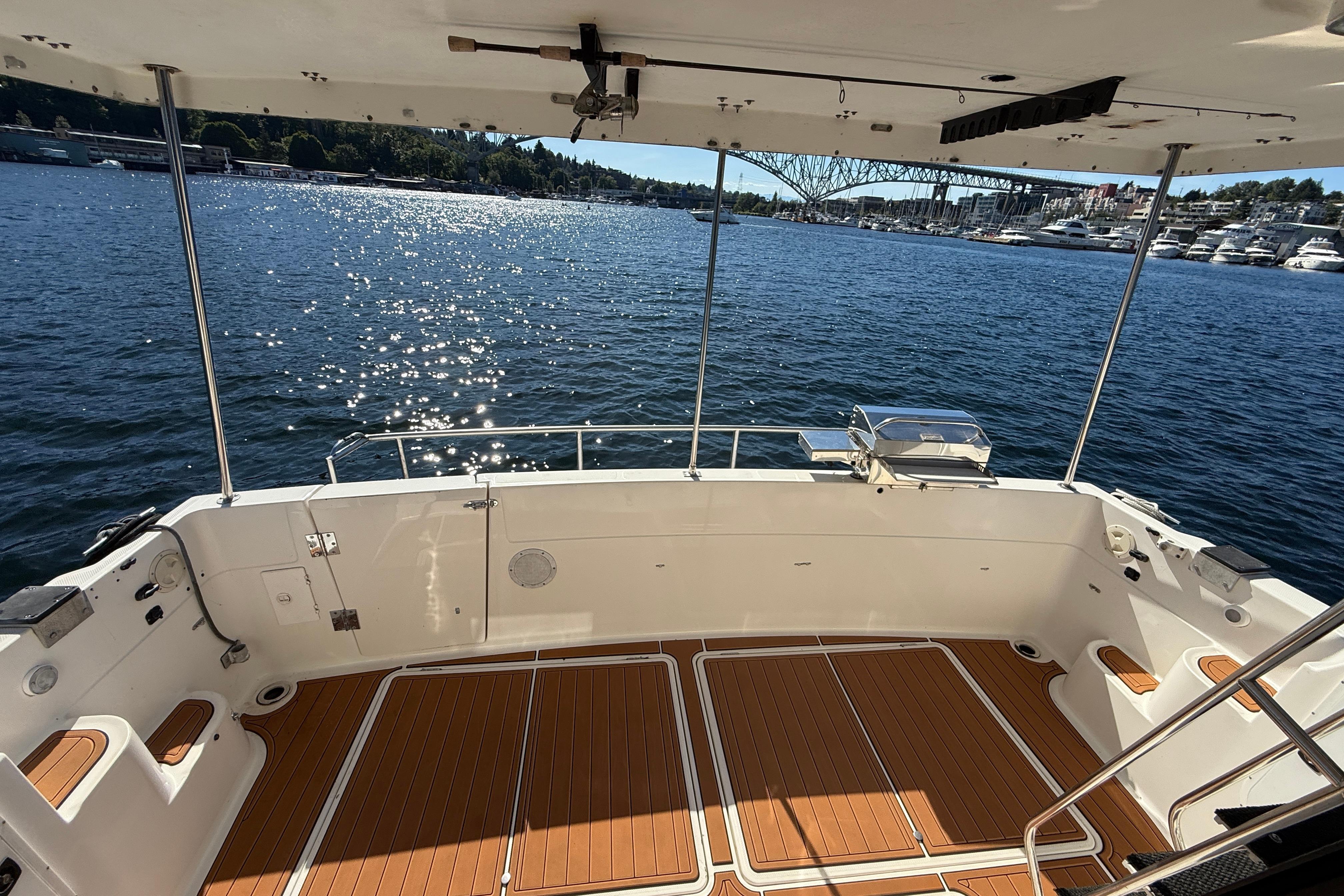 1997 Bayliner 3988 Command Bridge Motoryacht deck overlooking sparkling water and marina.