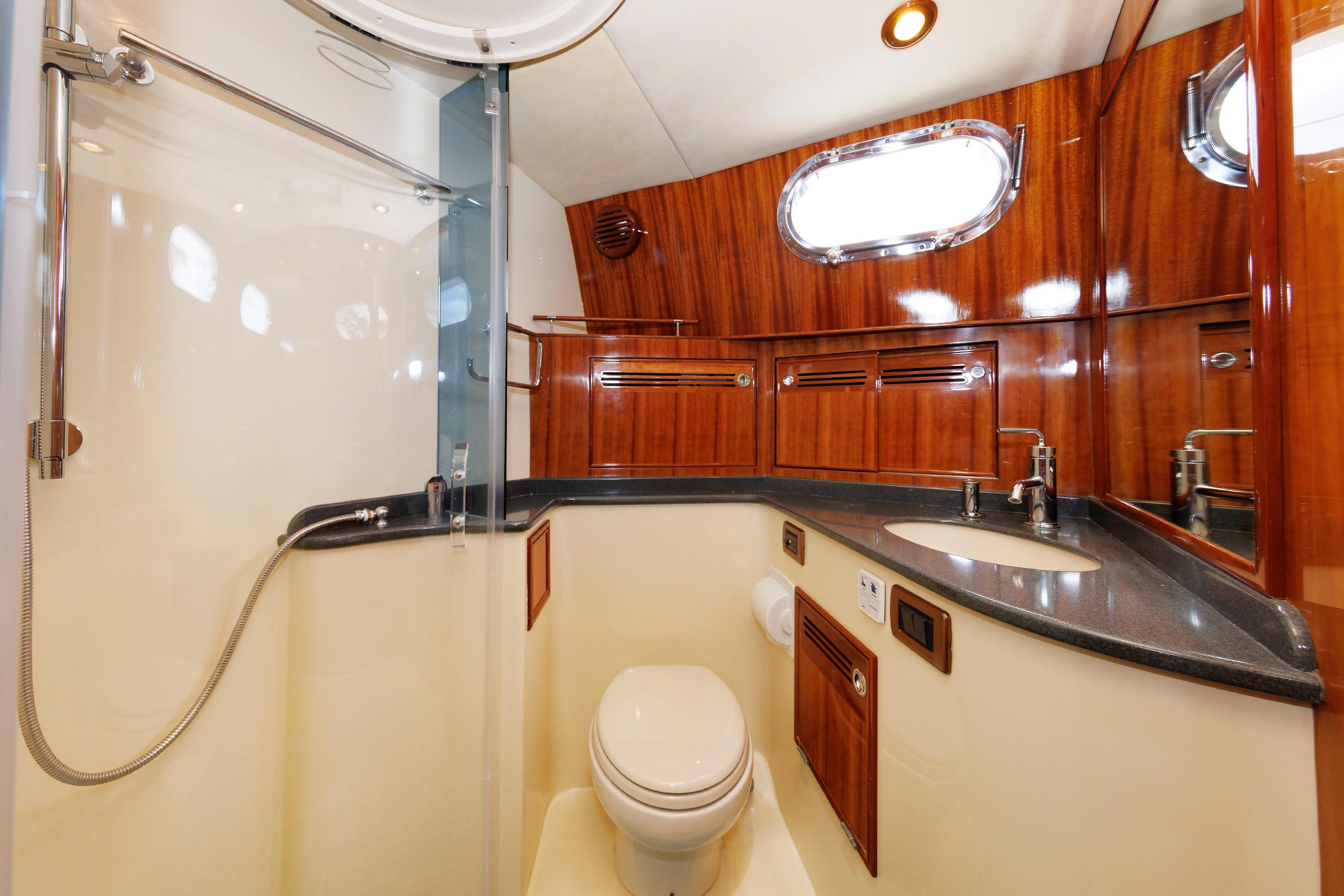Luxurious bathroom in 2009 Hunt Yachts 52 Express, featuring wood accents and modern fixtures.